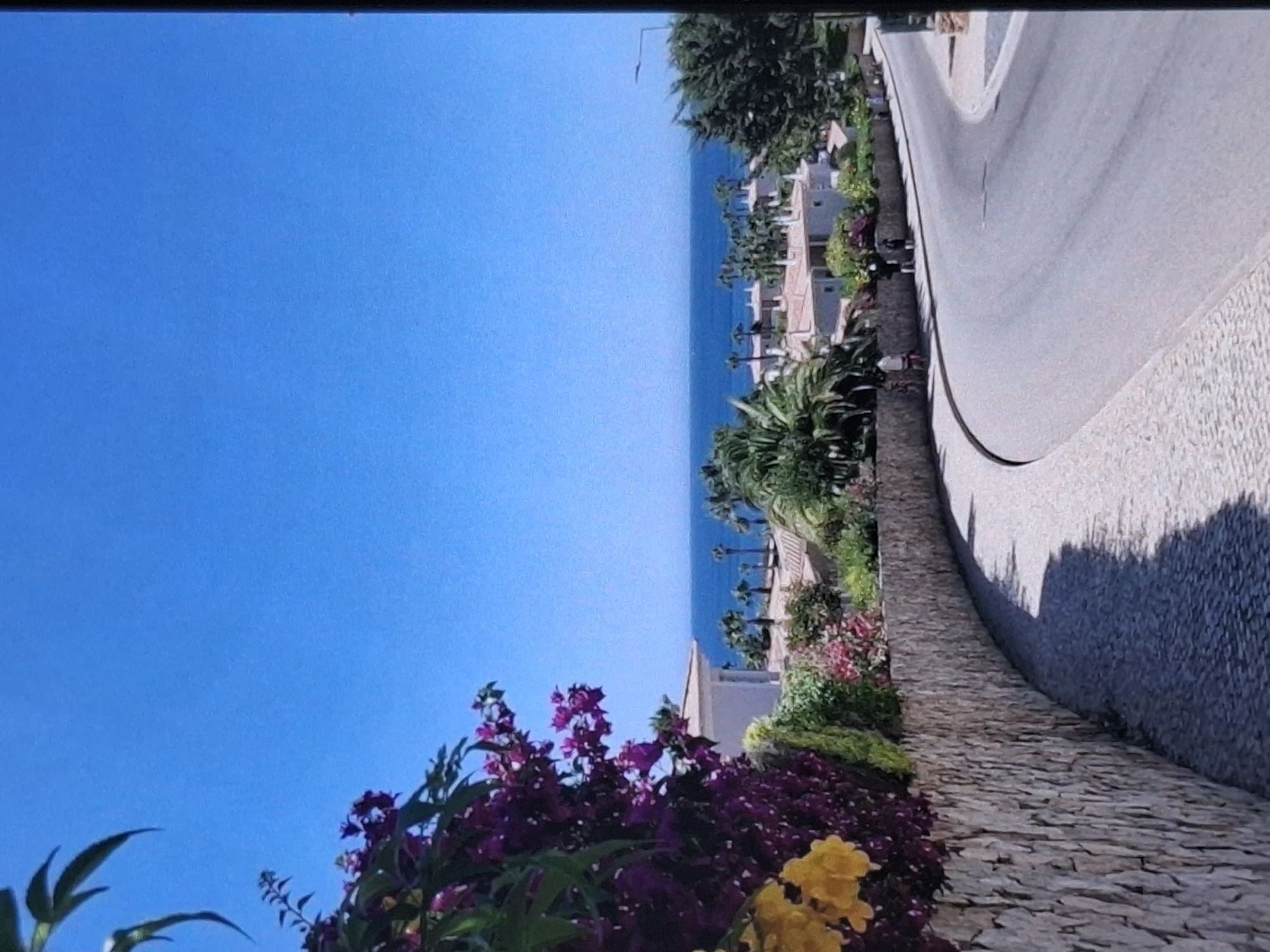 Person walks coastal promenade in sunny Burgas, Bulgaria