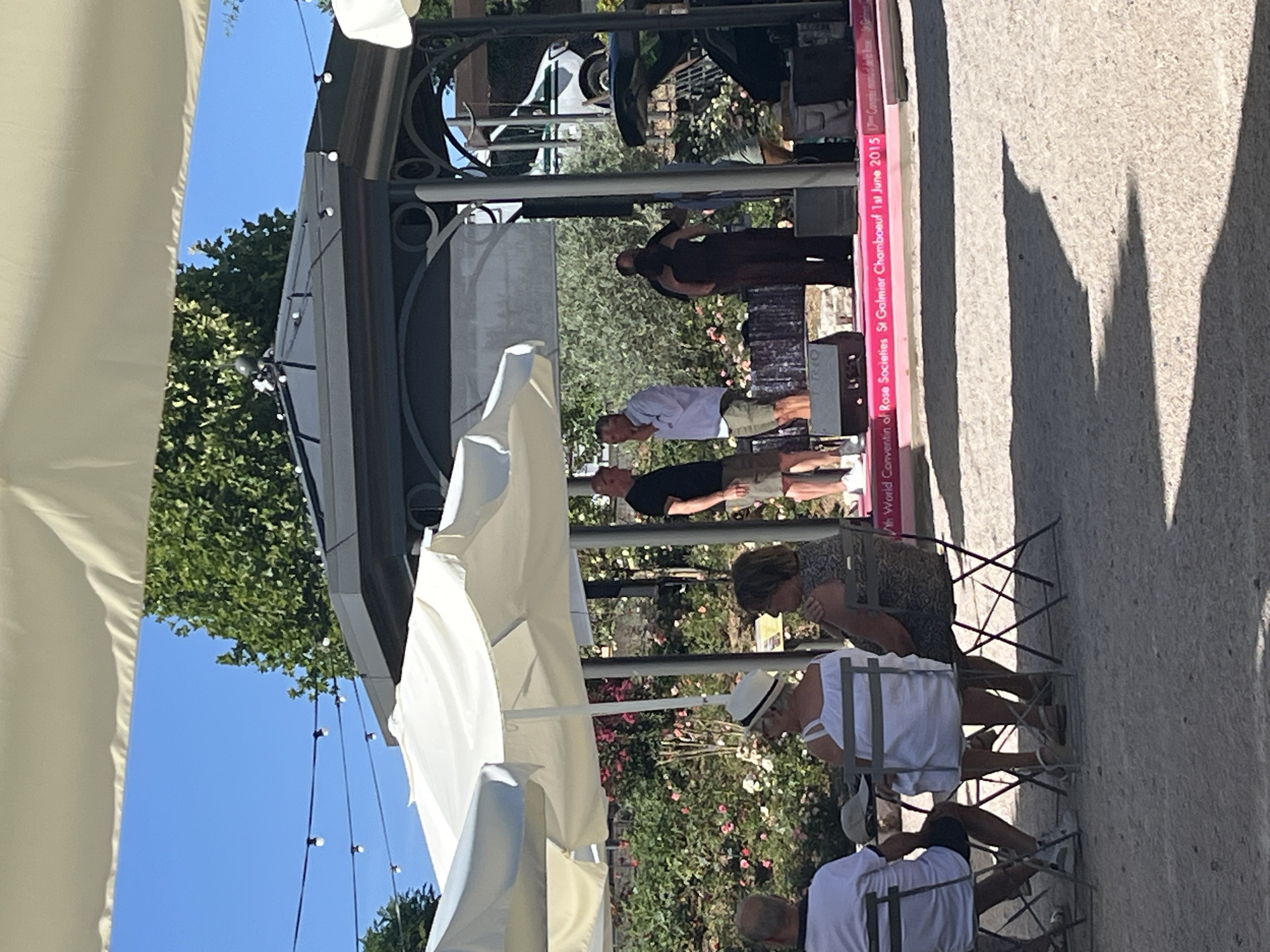 Outdoor gathering with stage and seated crowd in Chambœuf