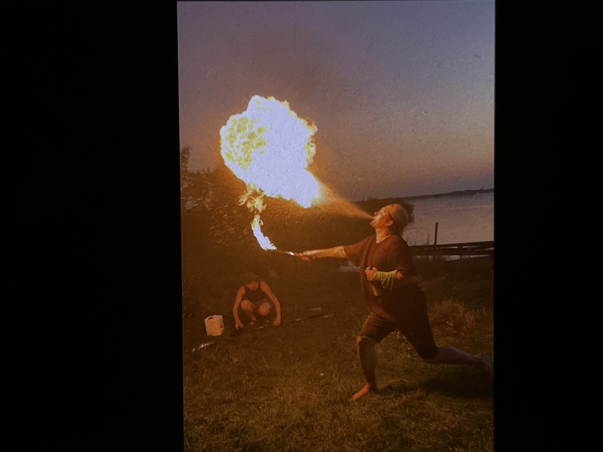 Fire performers work the Tyumen riverbank at dusk