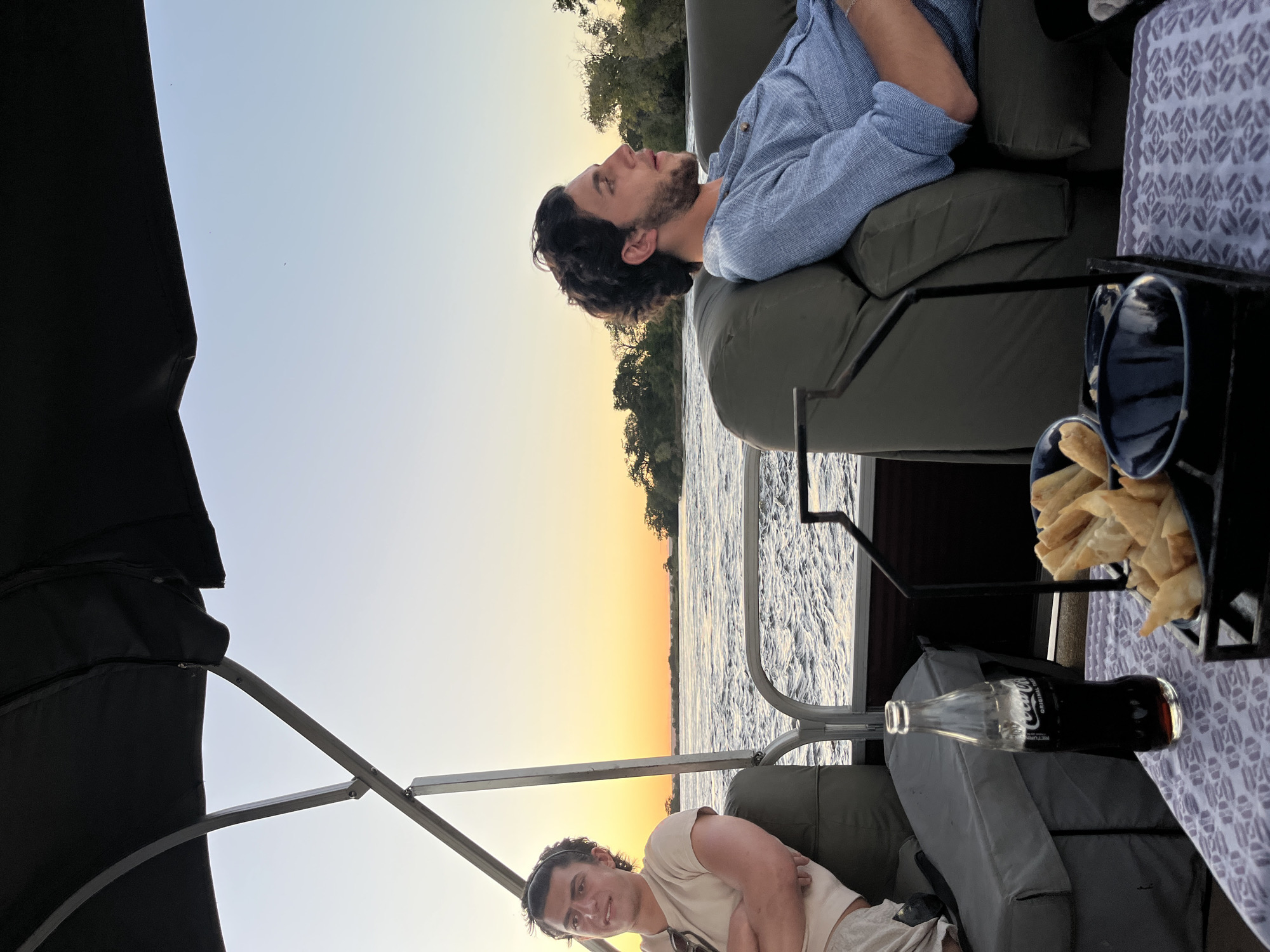 Men relax on boat near Victoria Falls, Zimbabwe