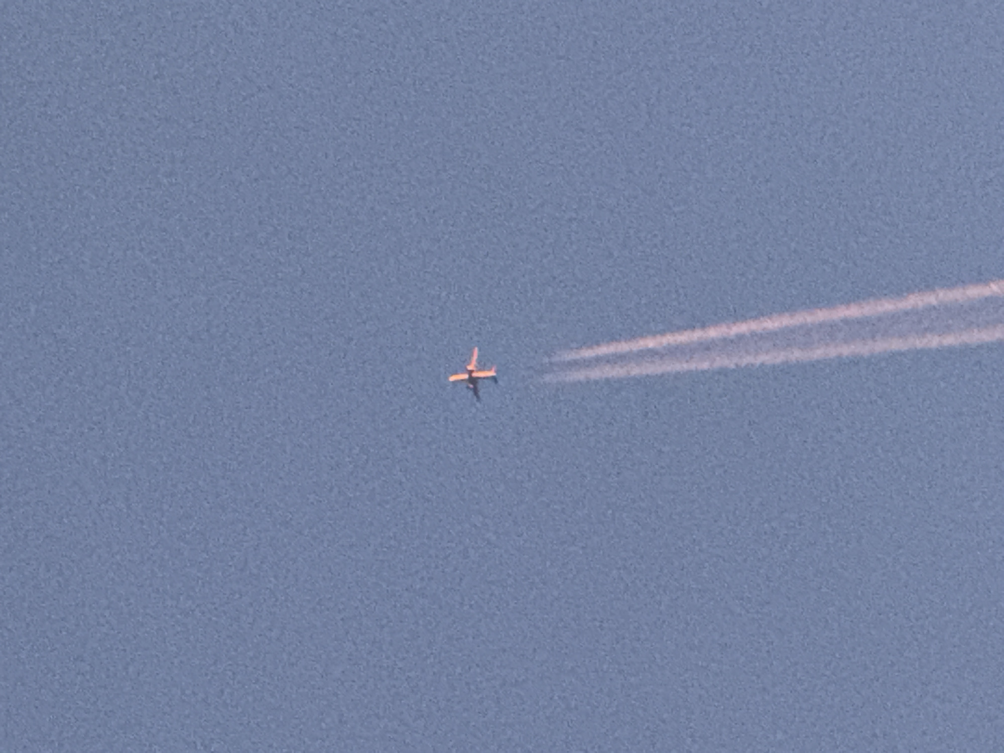 Planes, contrails, and a full moon over Norilsk skies