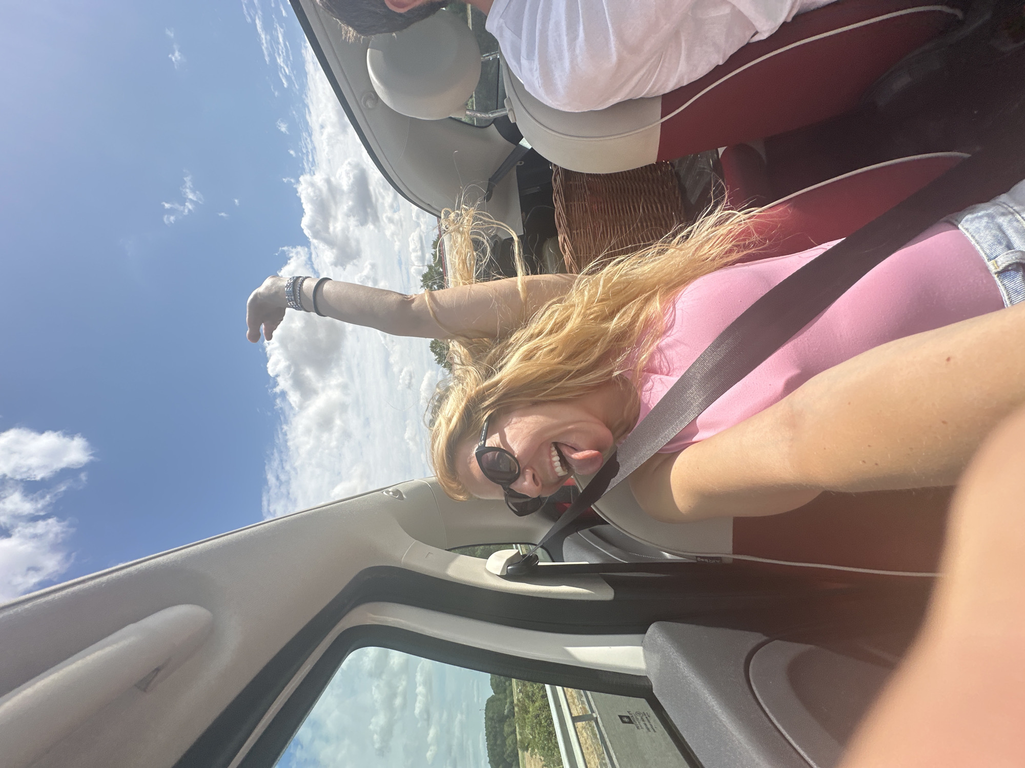 Convertible passenger goofing for the camera on a summer drive