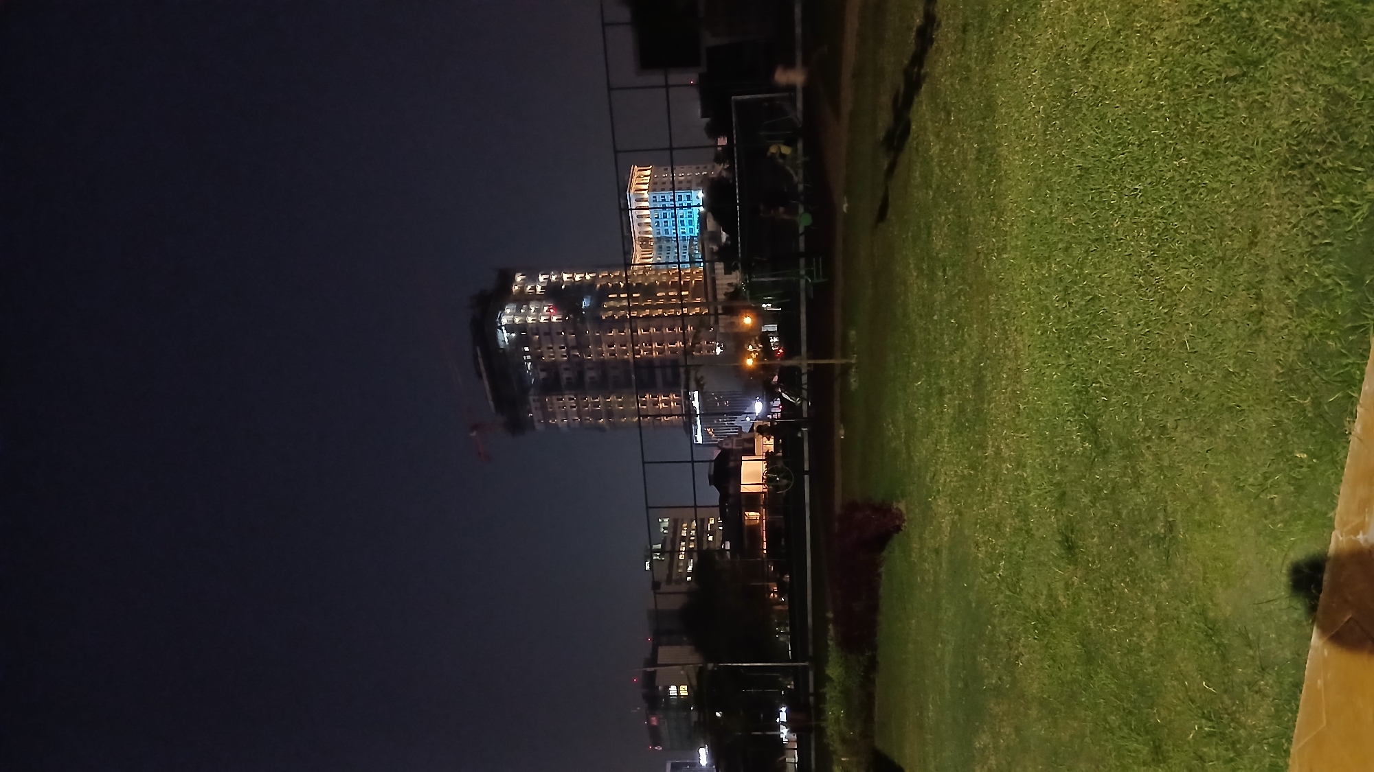 Evening at a Medan public park: playground, fitness gear, nighttime strolls