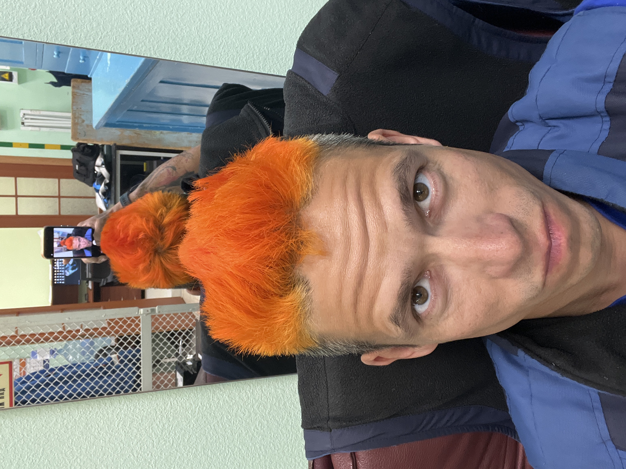 Orange-haired man photographed at mirror in Chaikovsky, Russia