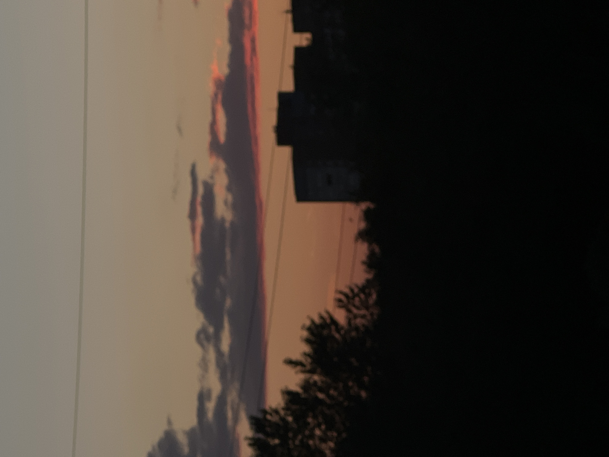 Sunset over Shushary's skyline, pylons and apartments in silhouette