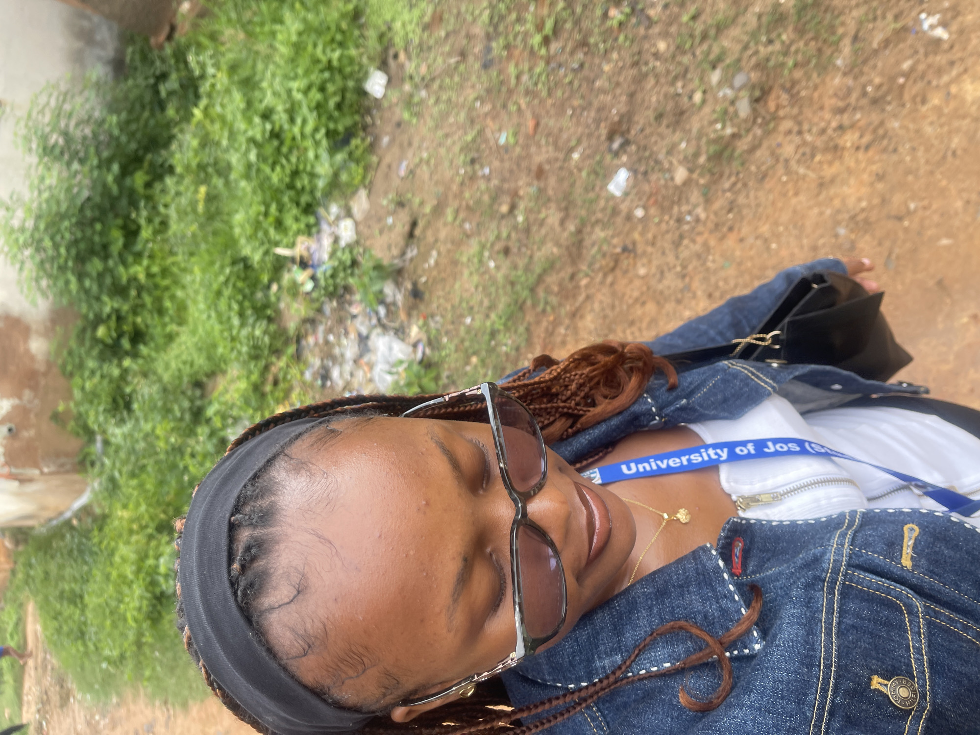University of Jos student taking selfies on a dirt path in Rafin Par
