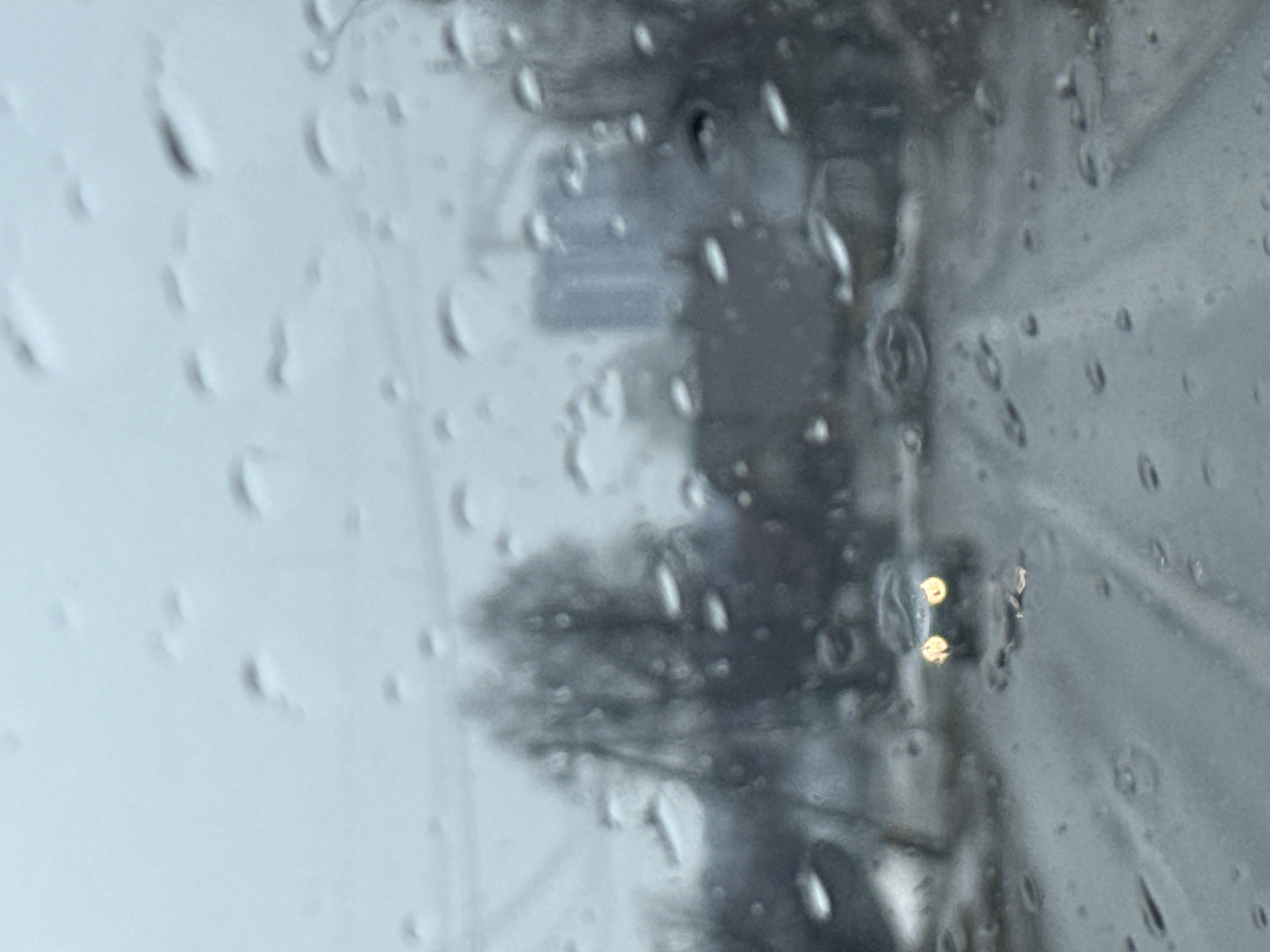Rainy street scene viewed through window in Chaikovsky, Russia