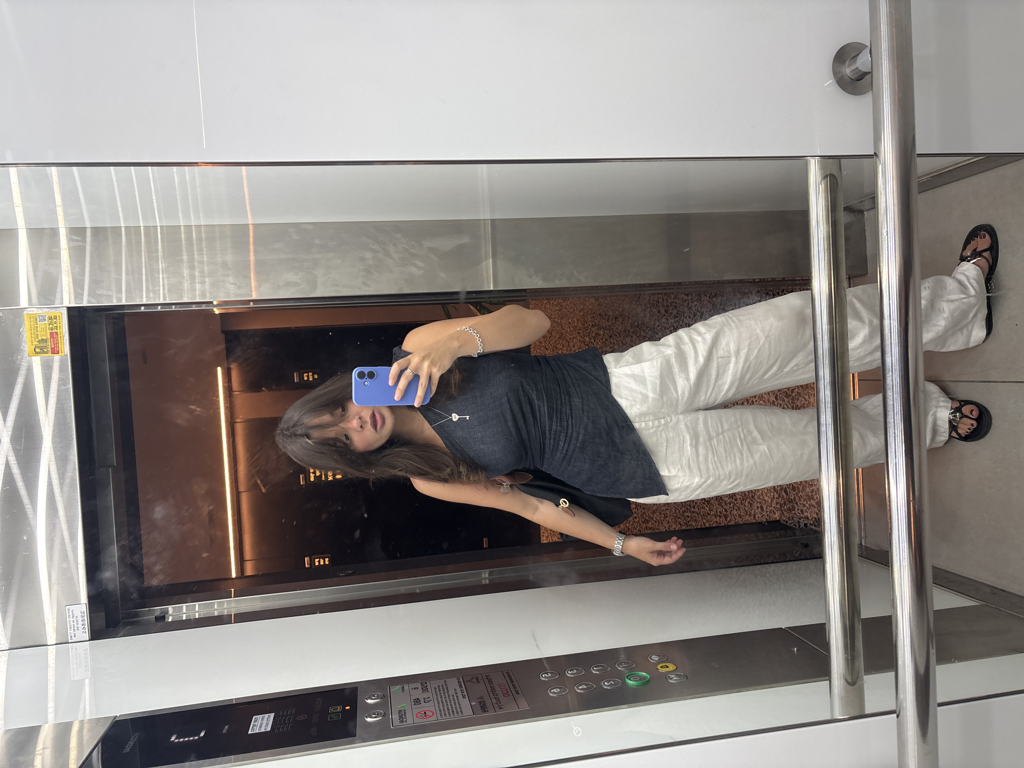 Woman takes elevator selfie in Tel Aviv morning