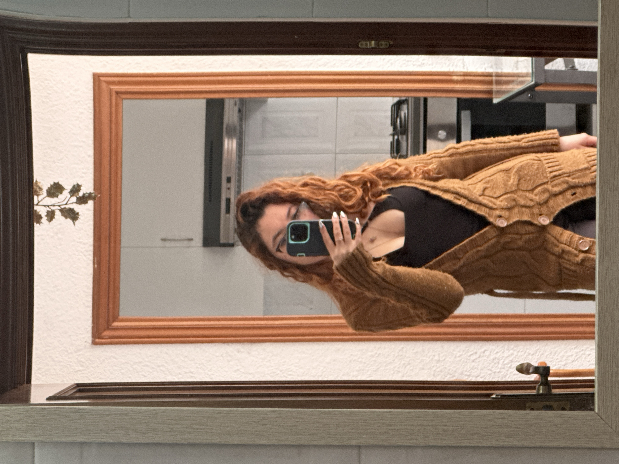 Woman takes mirror selfie in Barcelona kitchen