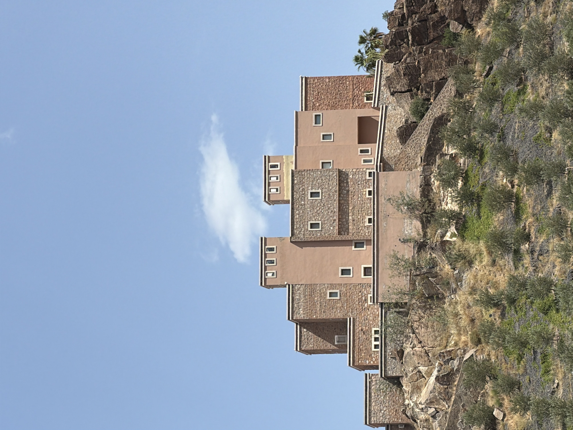 Terraced building complex observed on rocky hillside in Marrakesh