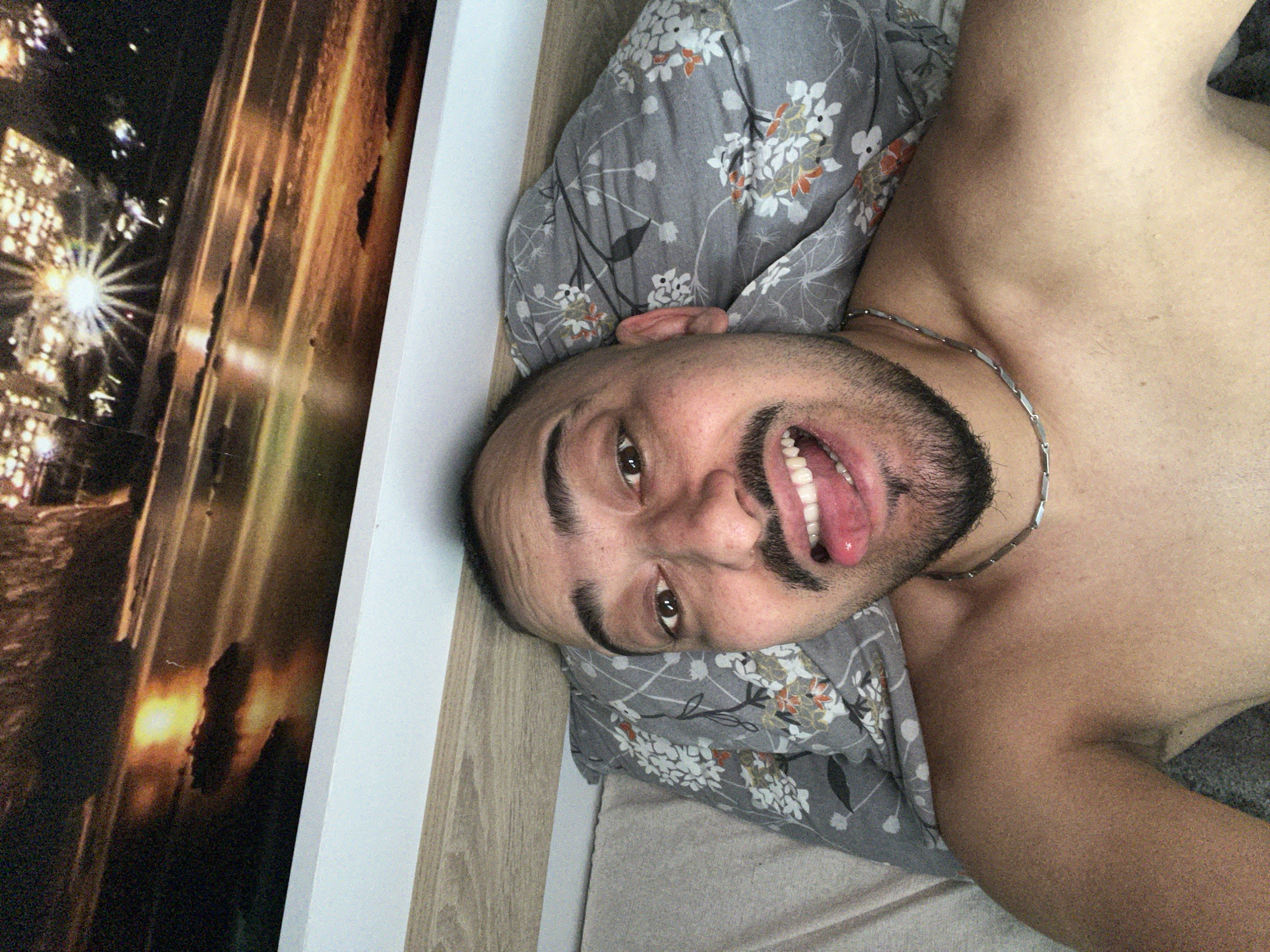 Man poses playfully on bed in Bulgarian village