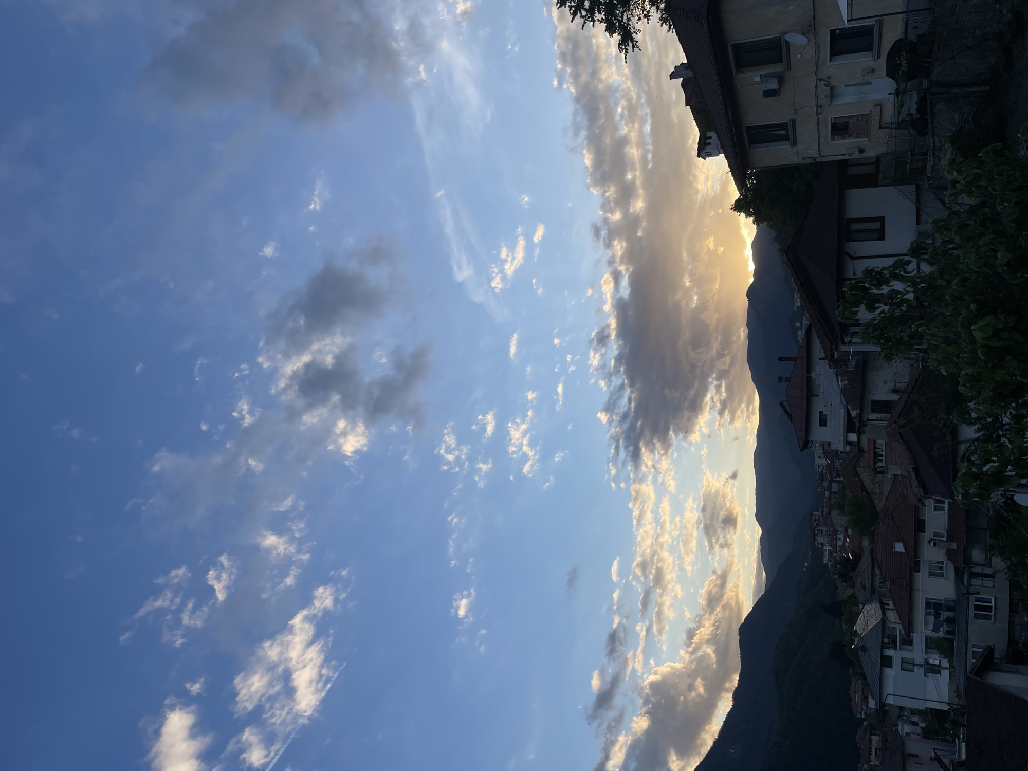Cat watches over Smolyan from windowsill during golden hour