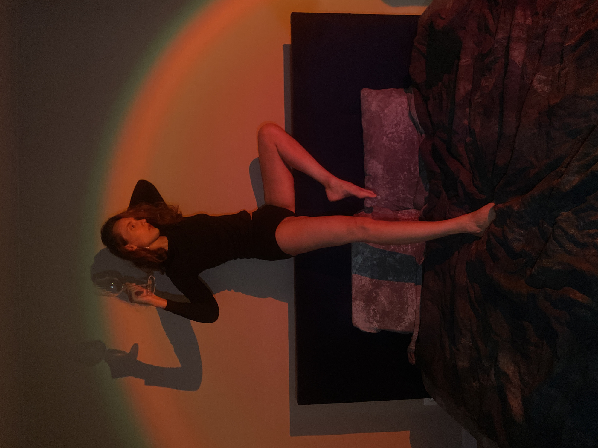 Woman relaxes with wine glass in Russian home