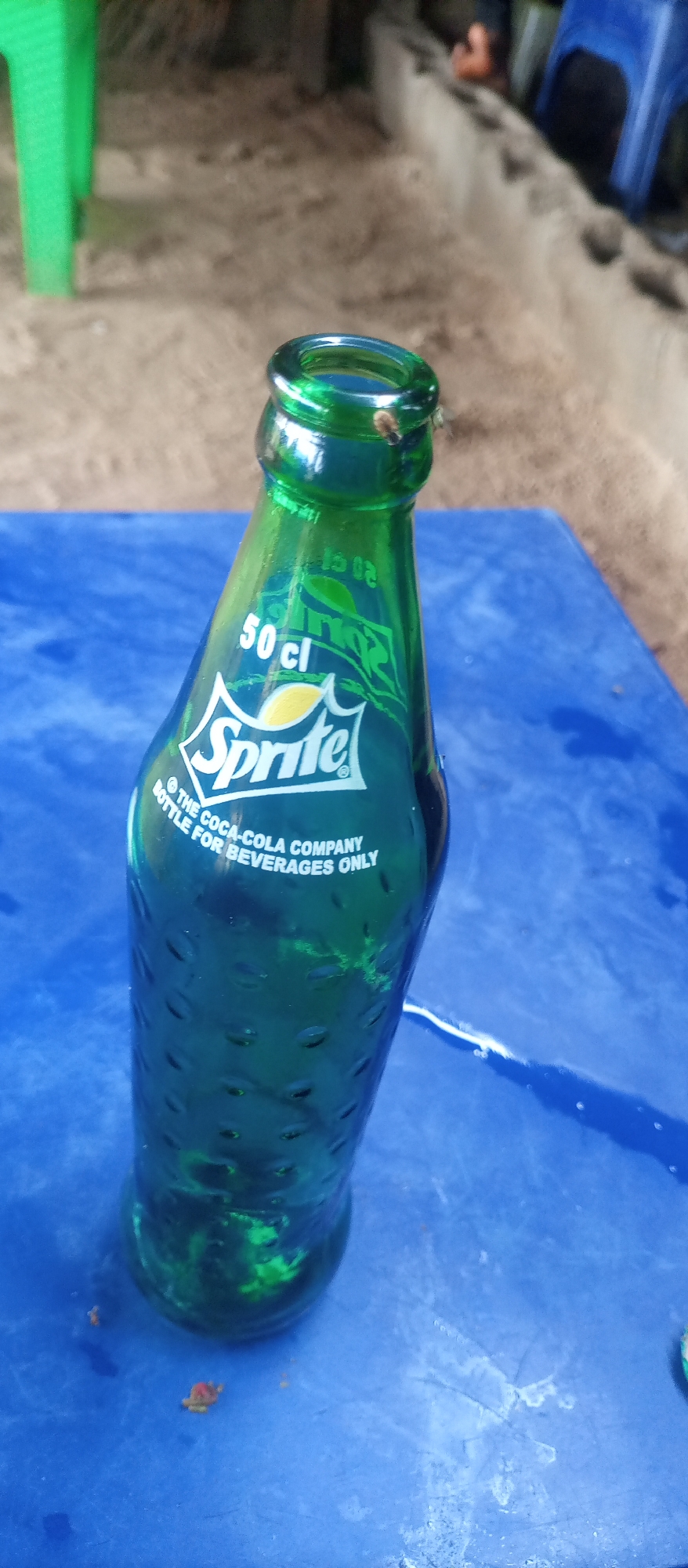 Casual outdoor dining scene captured with Sprite bottle