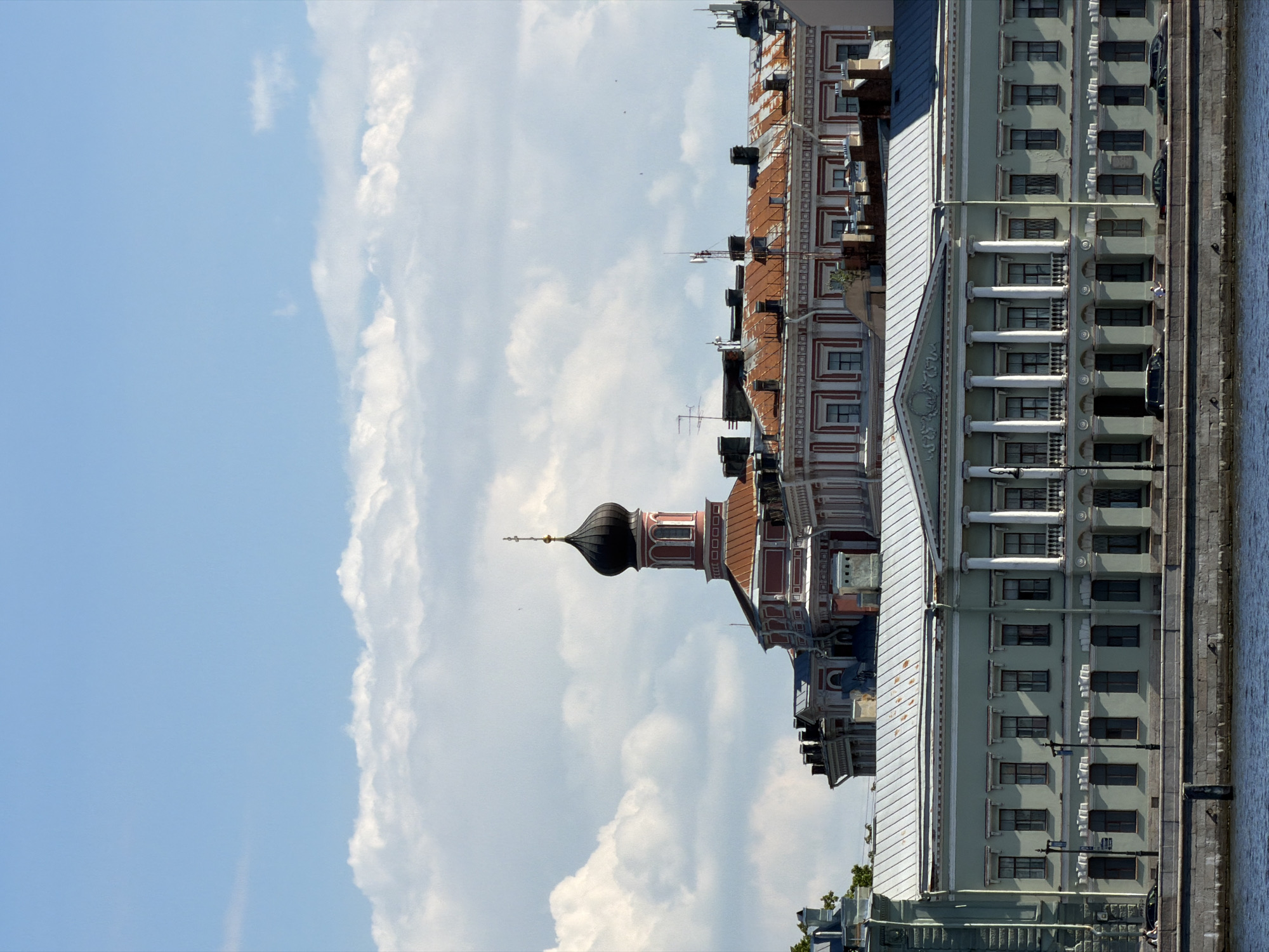 Tourist explores Saint Petersburg waterfront landmarks on sunny afternoon