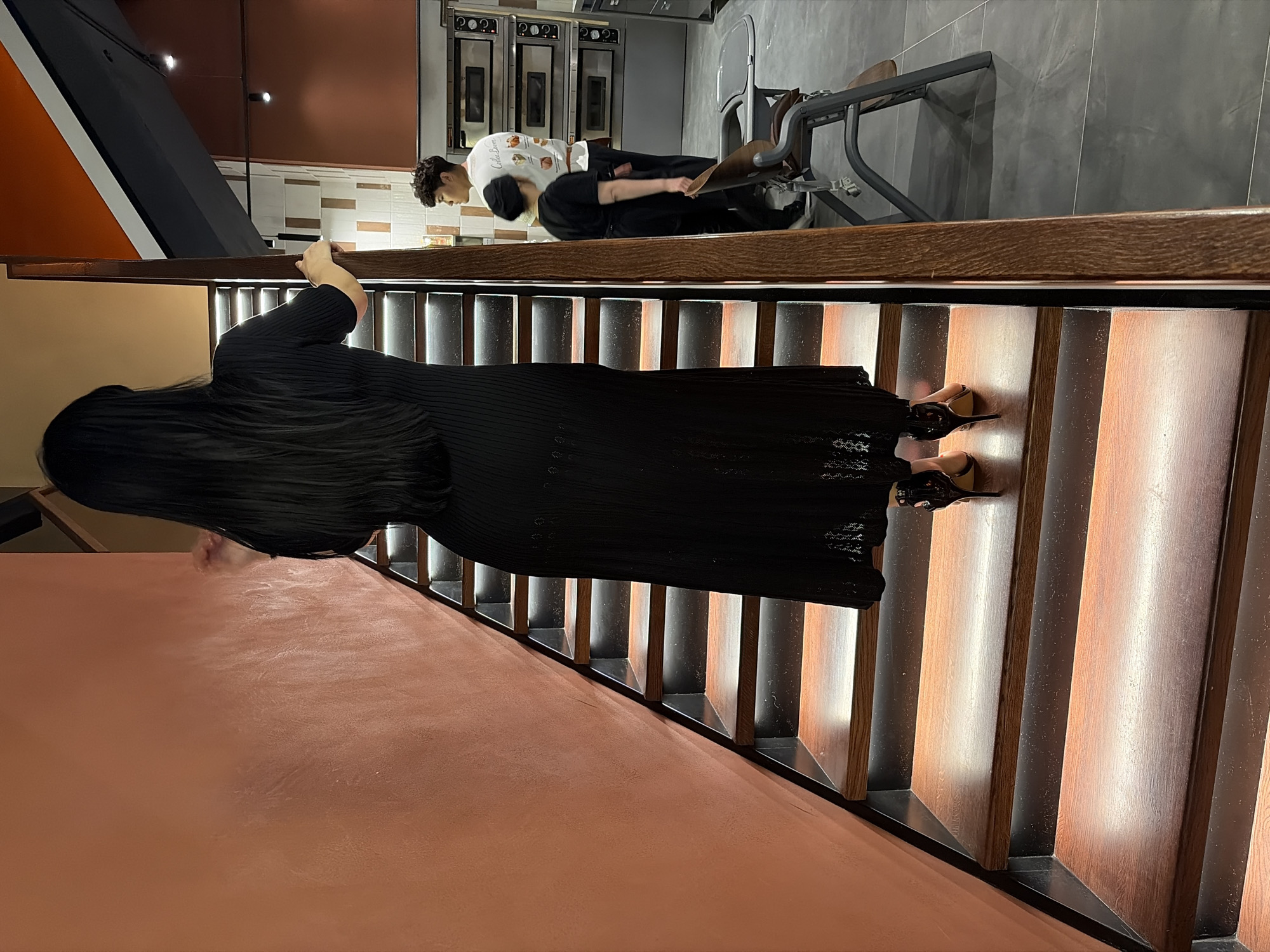 Woman in black dress documented during routine evening in Astana