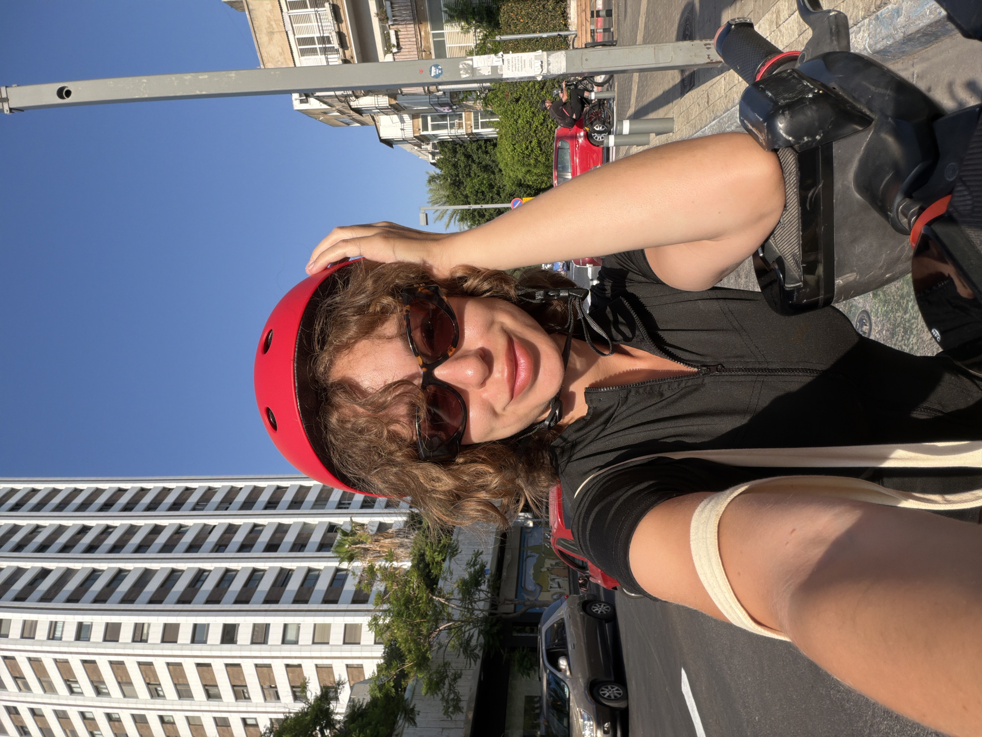 Helmet-on selfie from a scooter stop in Tel Aviv