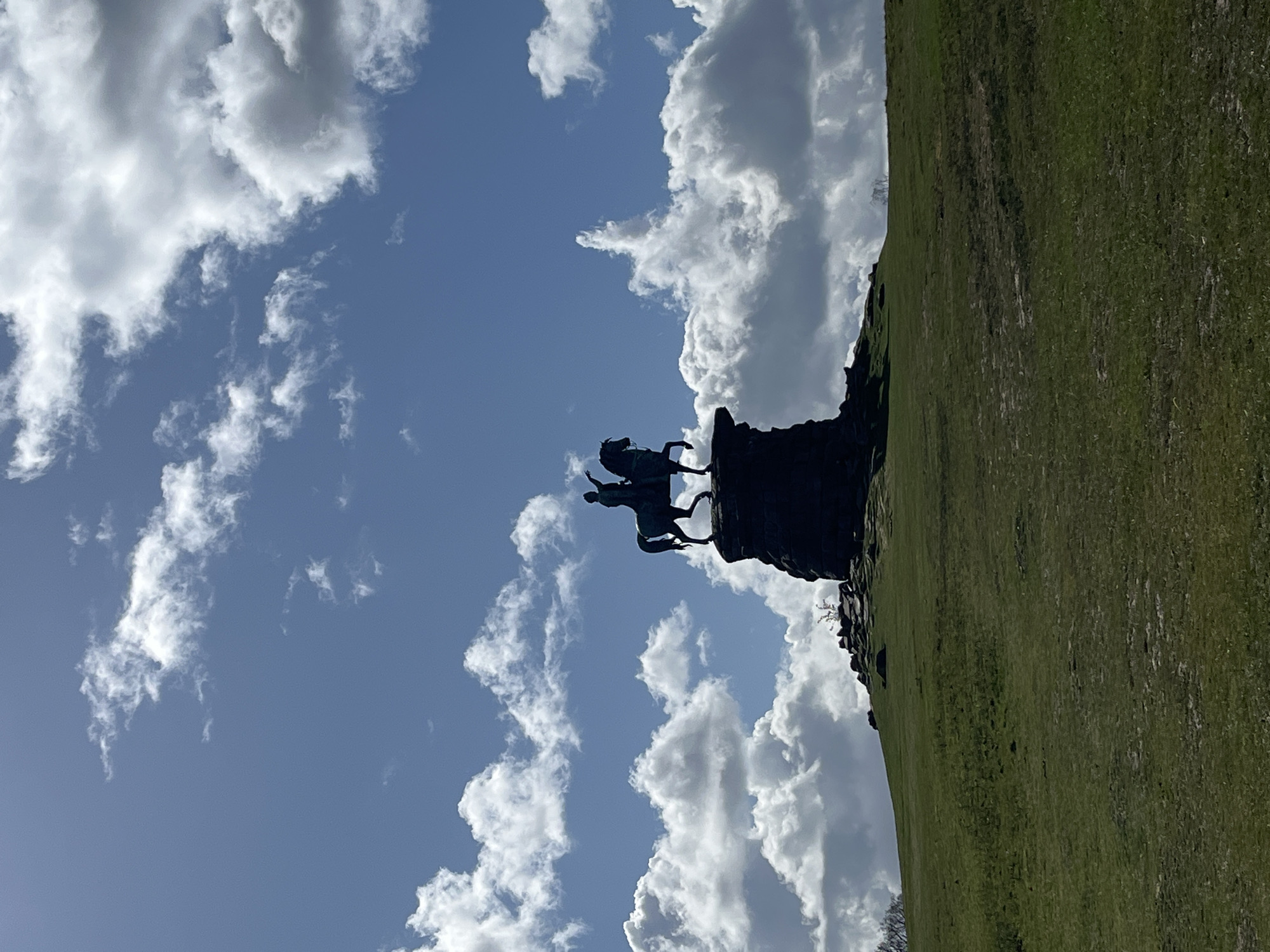 Equestrian statue and park pathway captured in UK village