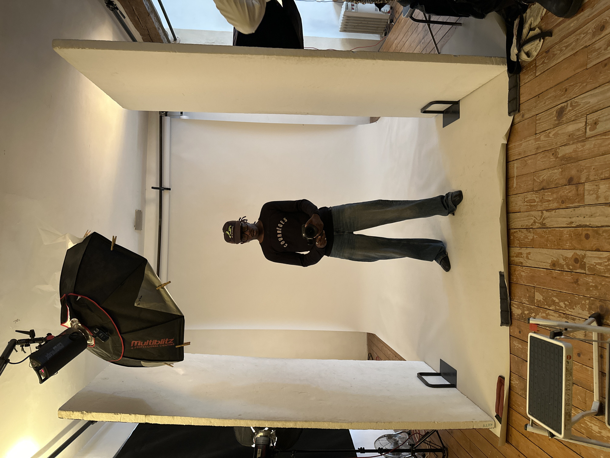 Man photographed in makeshift studio wearing Courrèges shirt, Paris