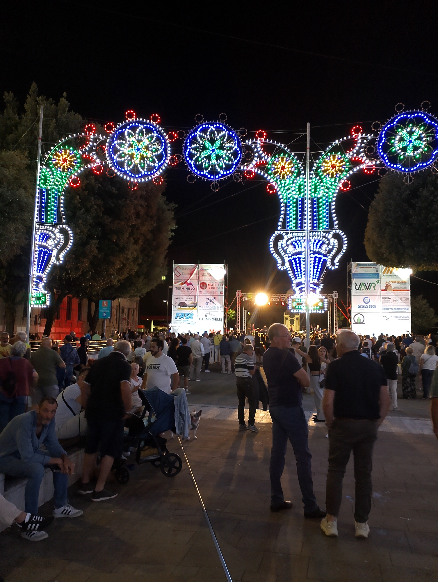 Evening festival lights and live stage setup in Rieti, Italy