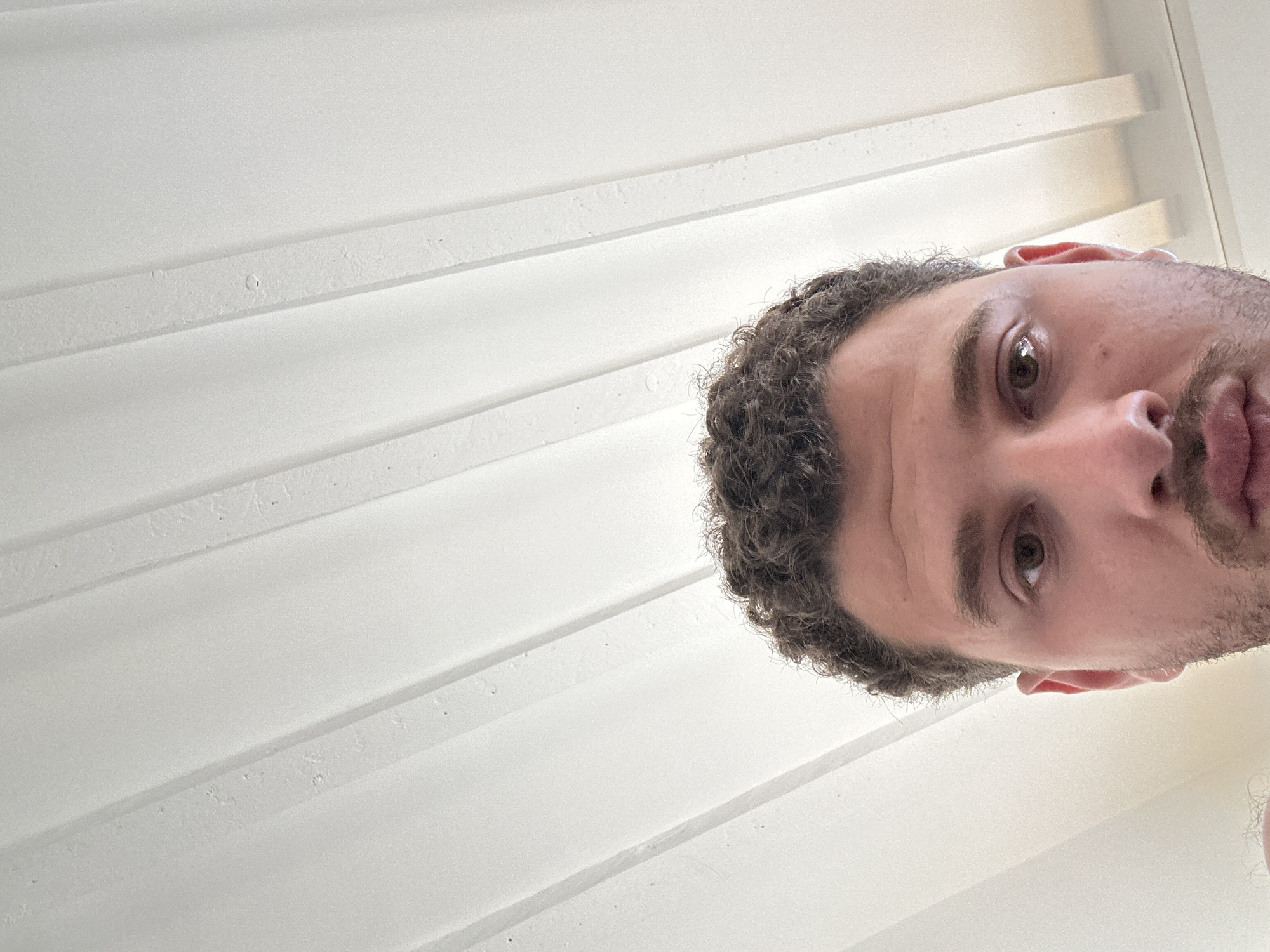 Person photographed in modern Milan workspace