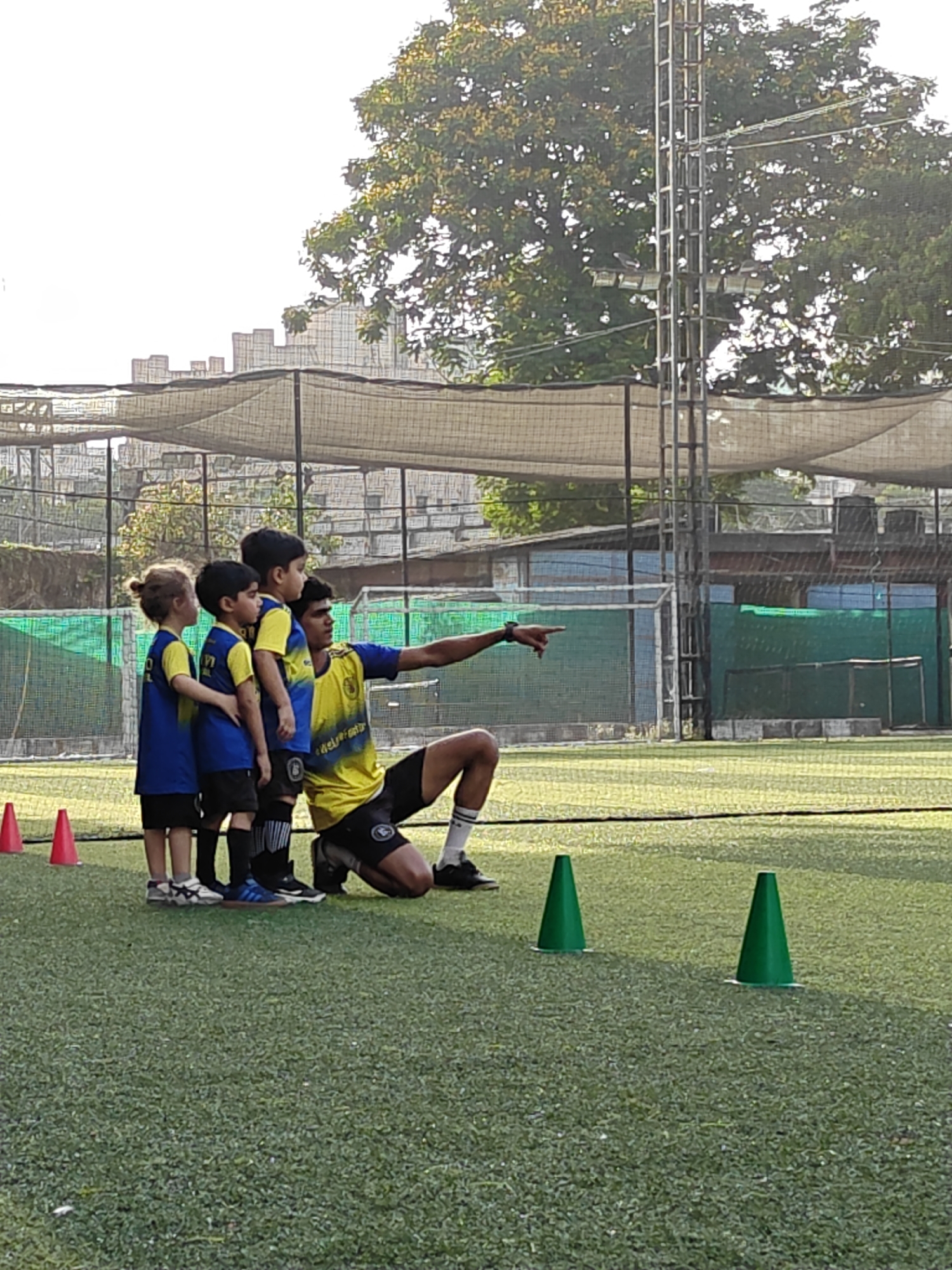 Youth soccer team practices drills on Mumbai field