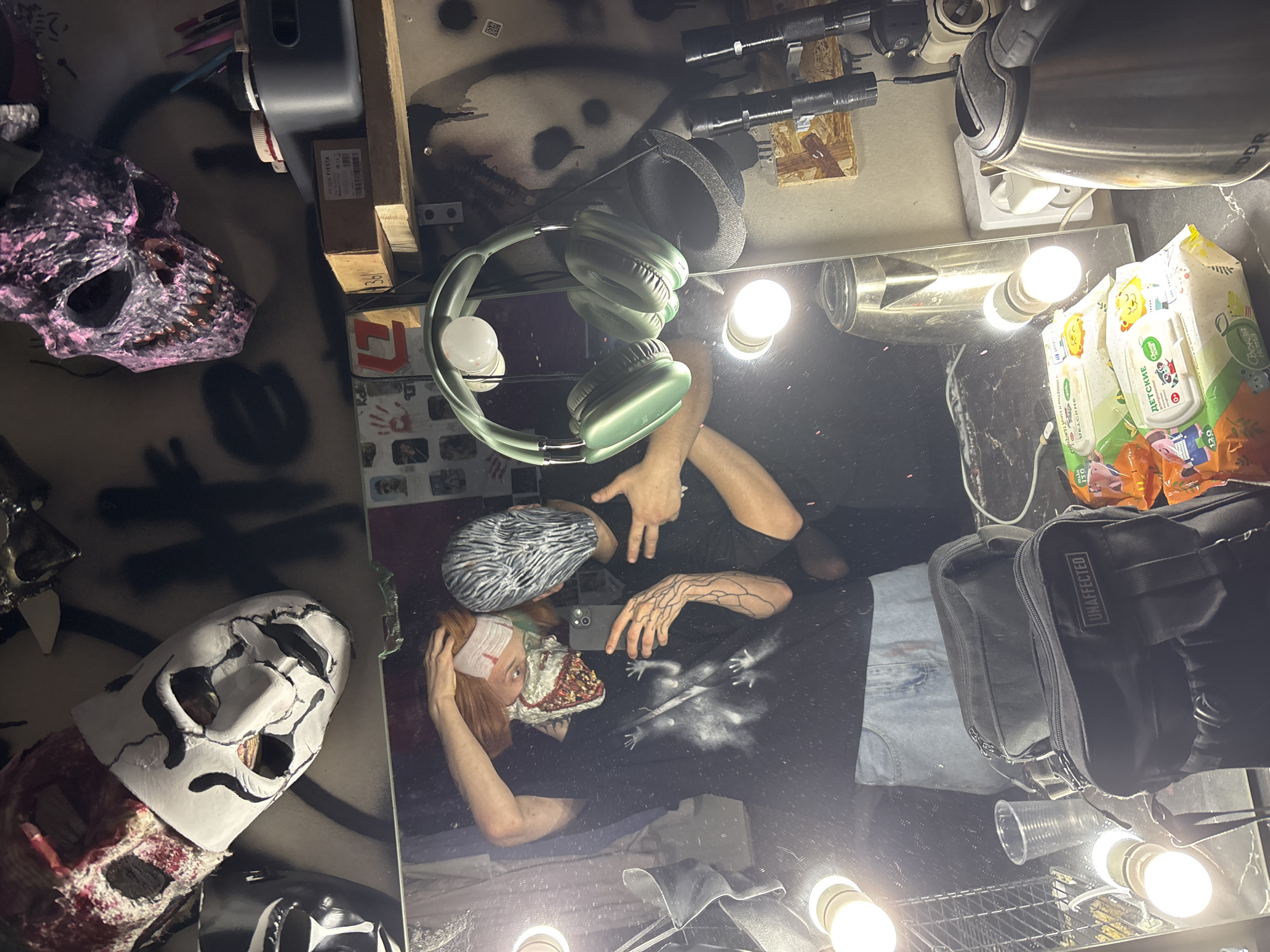 Masked person takes mirror selfie at vanity in Saratov