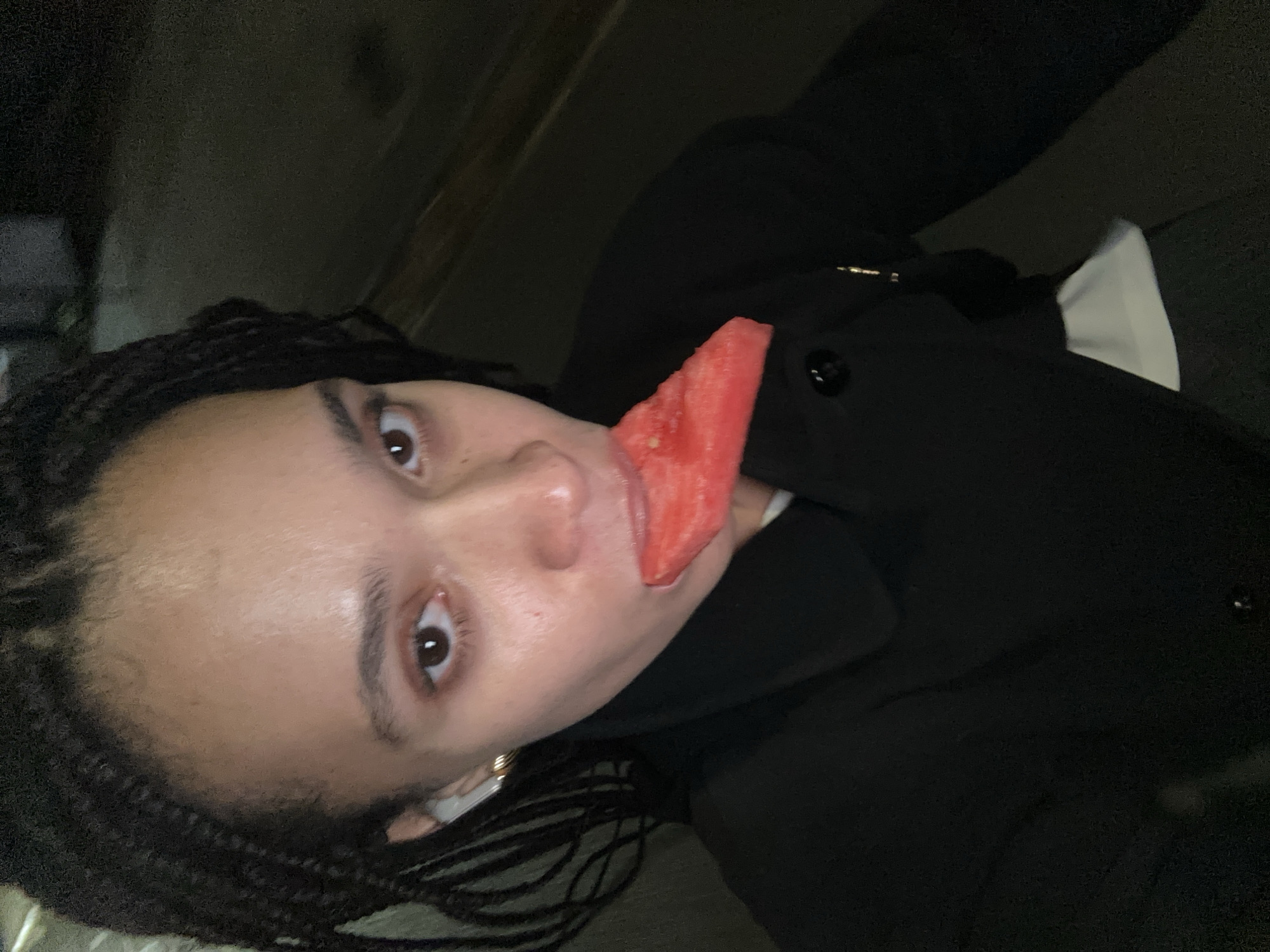 Person enjoys watermelon snack in London evening