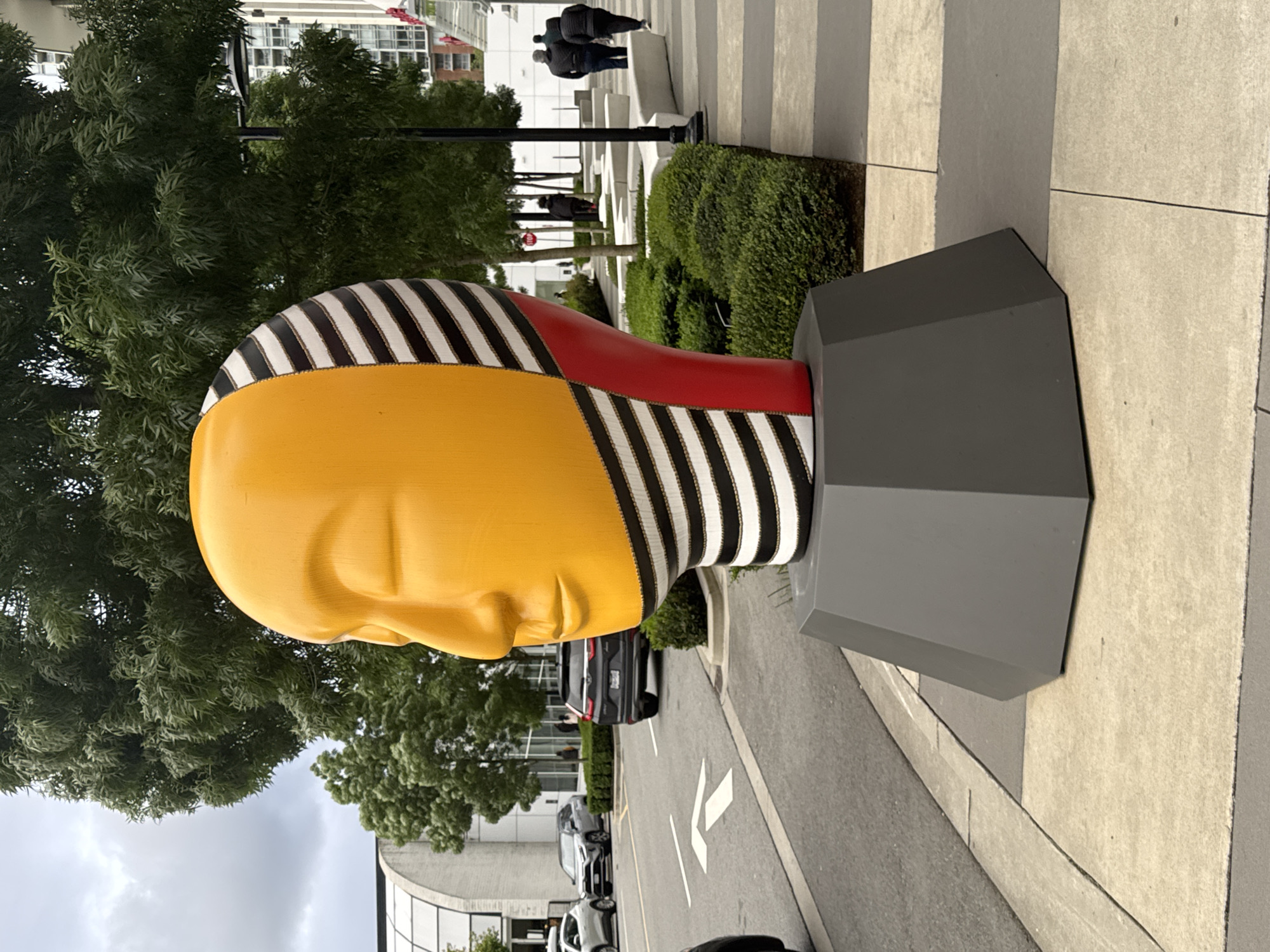 Colorful abstract head sculpture observed in urban Burnaby
