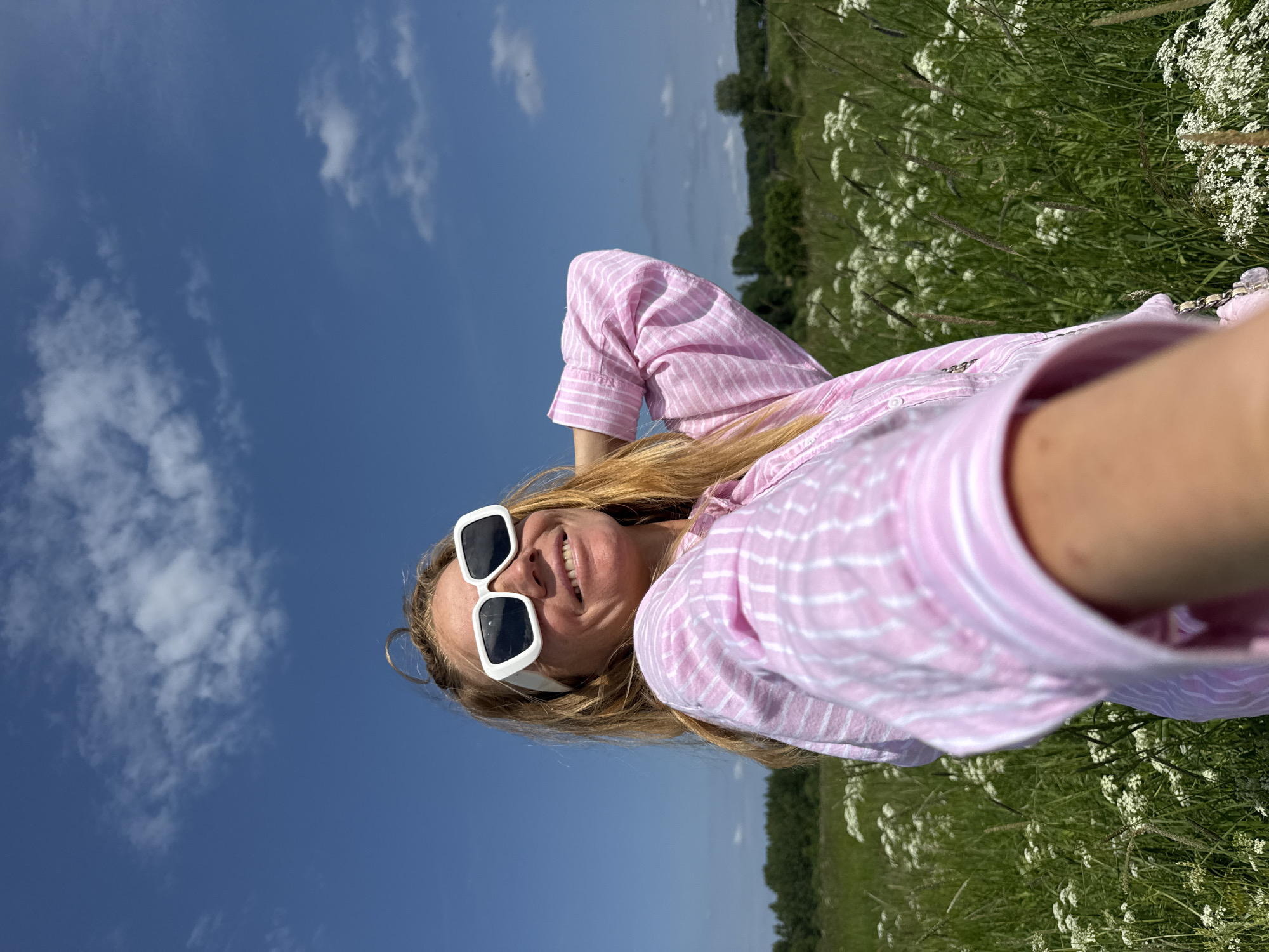 Woman documents wildflower meadow visit with selfies in Russia