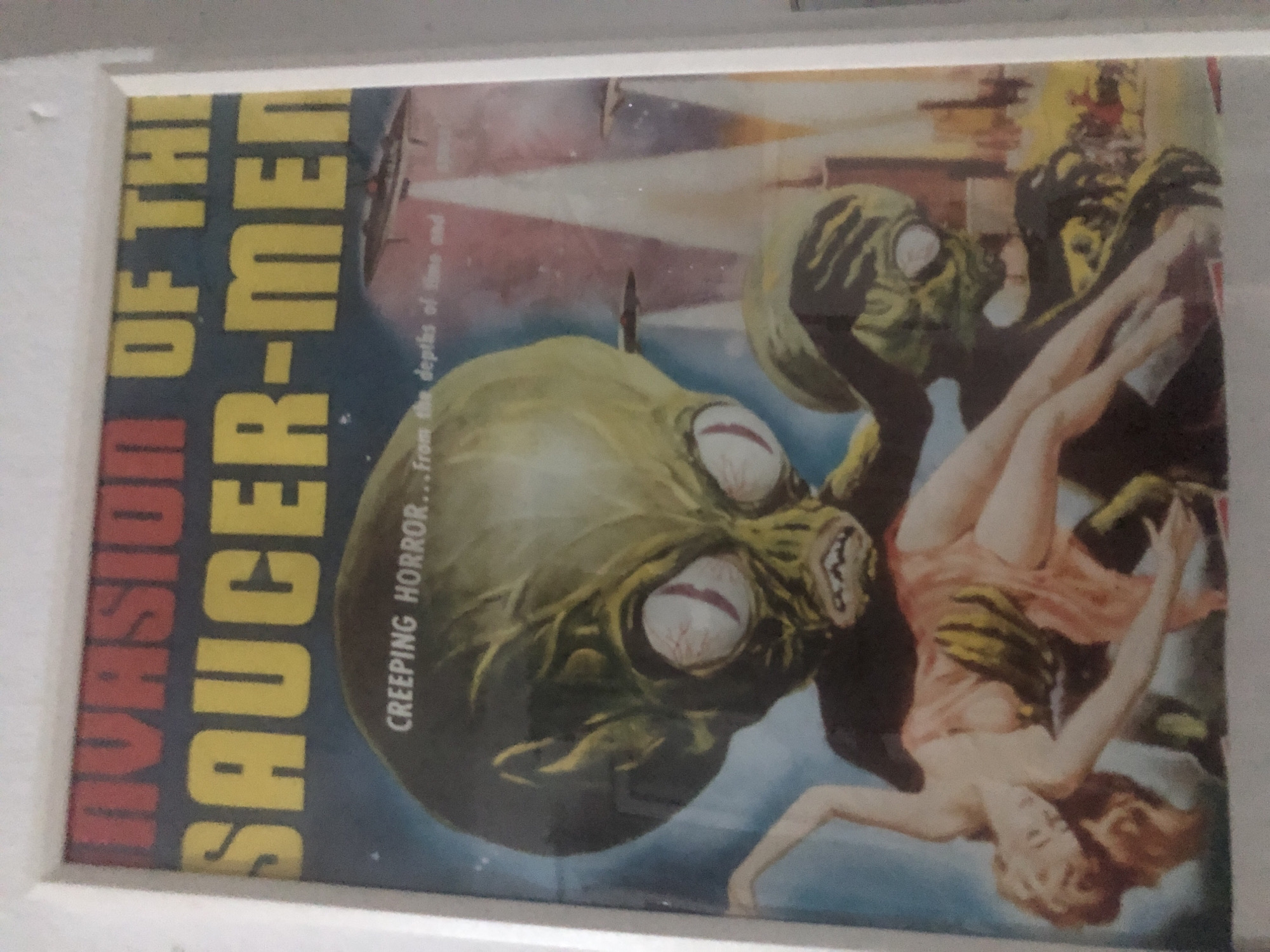 Vintage sci-fi movie posters and personal items documented