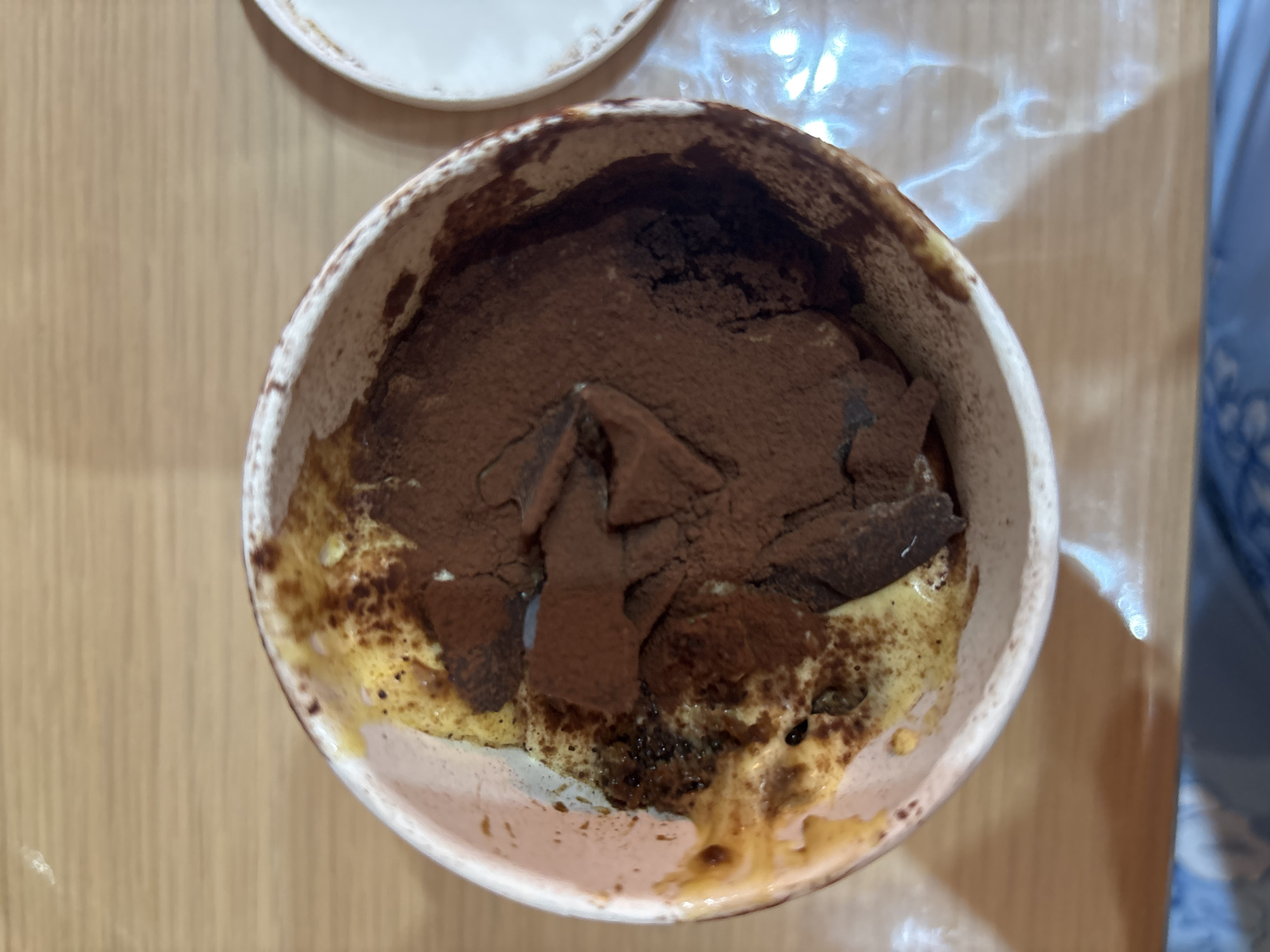 Tiramisu dessert captured in rustic serving dish in Rome