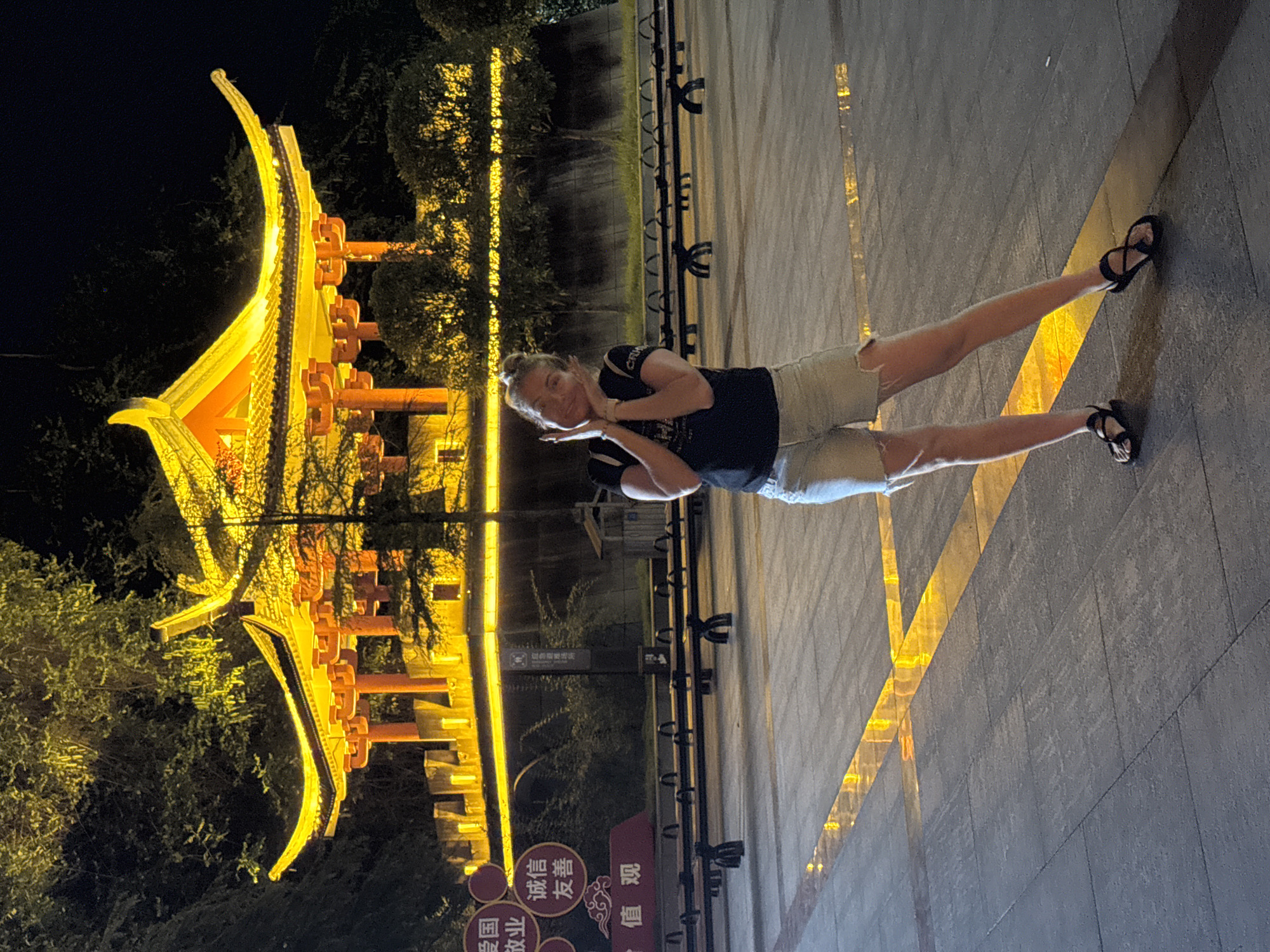 Illuminated traditional pavilion glowing at night in Yongding District
