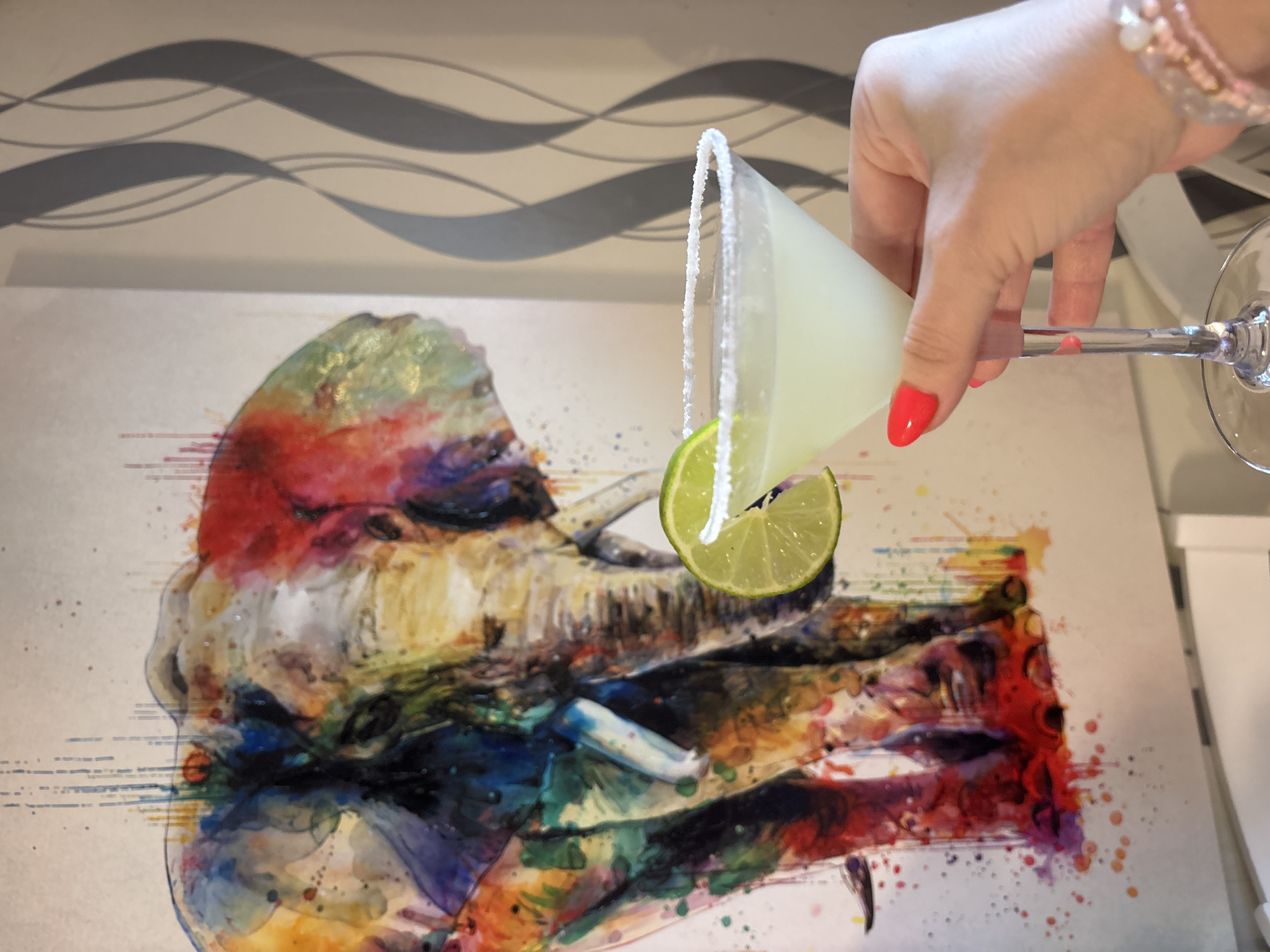 Person enjoys margarita cocktail at home in Sofia