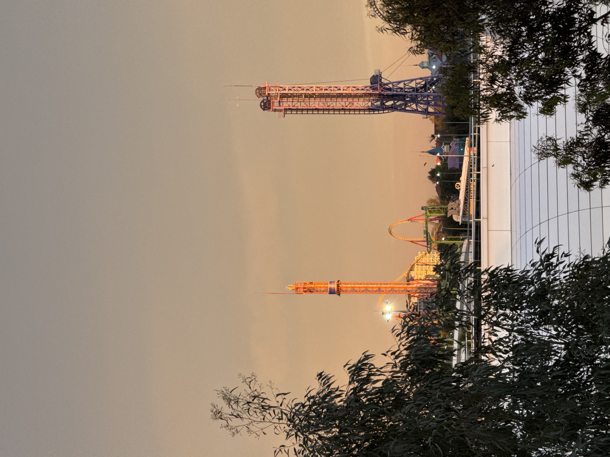 Amusement park with colorful towers documented at dusk in Sirius