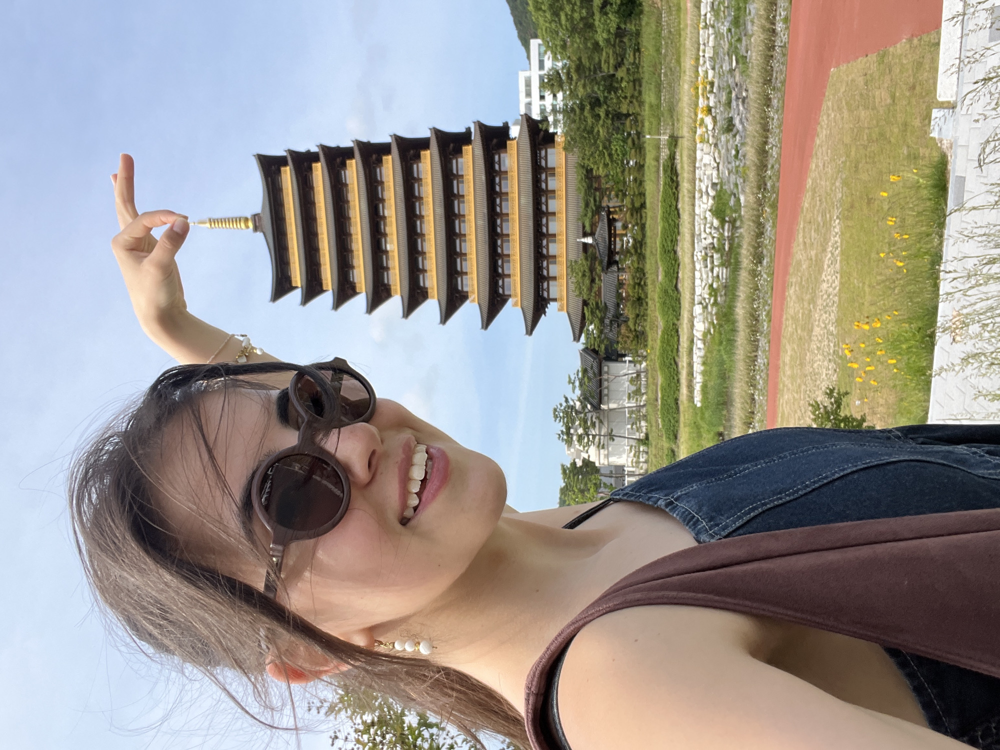 Tourist poses with historic pagoda in Gyeongju morning selfie