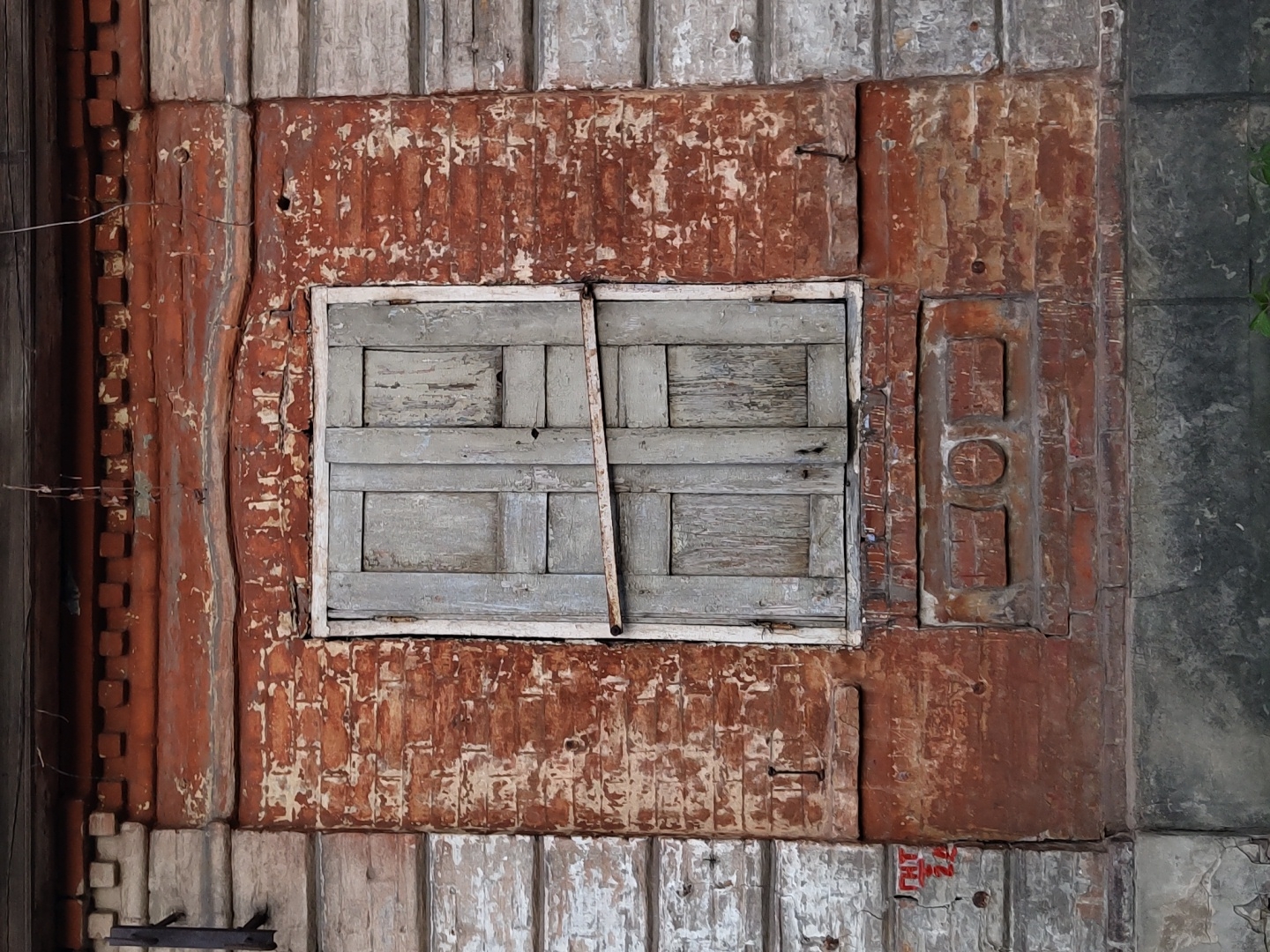 Weathered window documented on deteriorating wooden wall structure