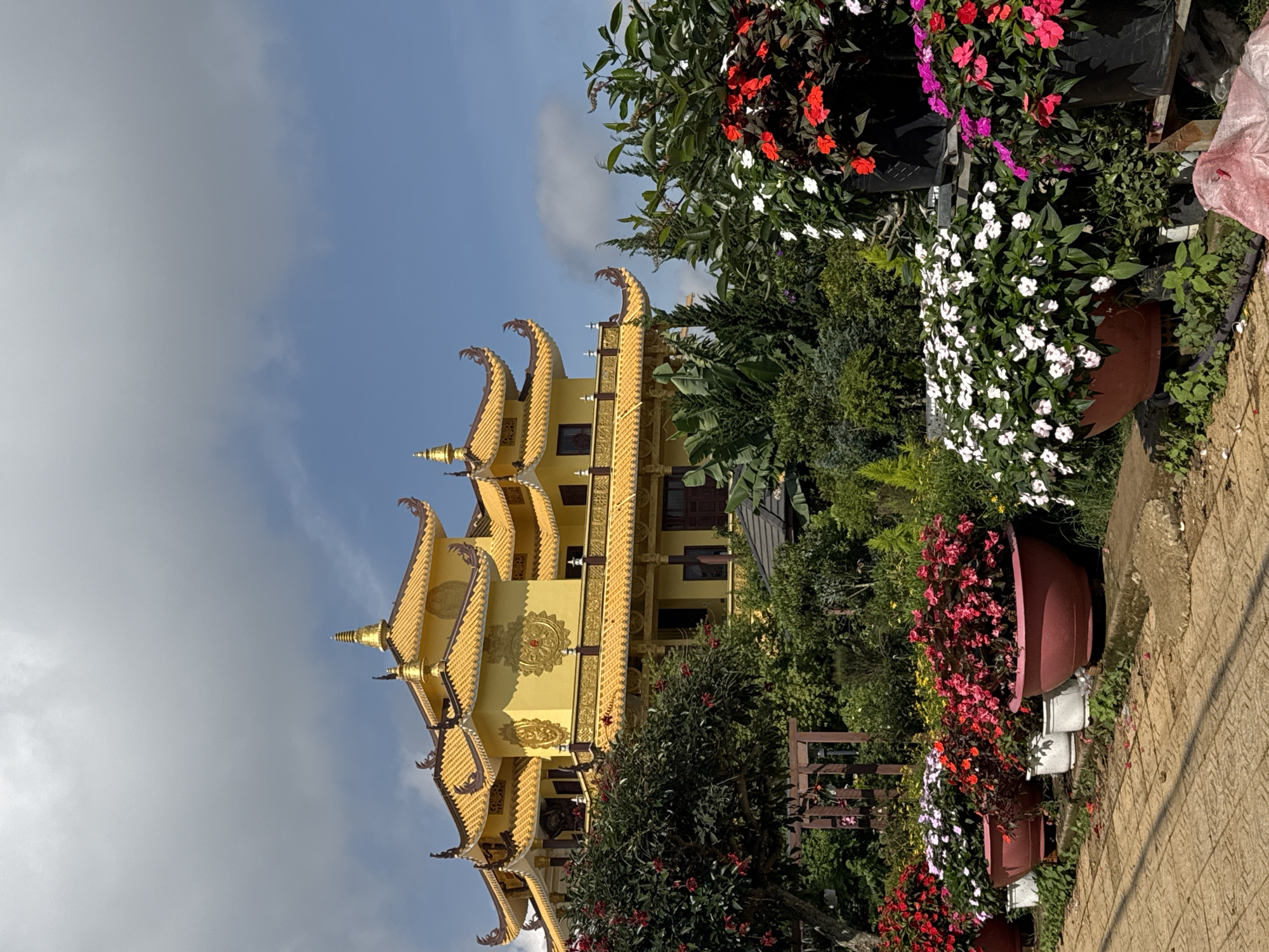 Golden Buddhist temple documented in Da Lat gardens