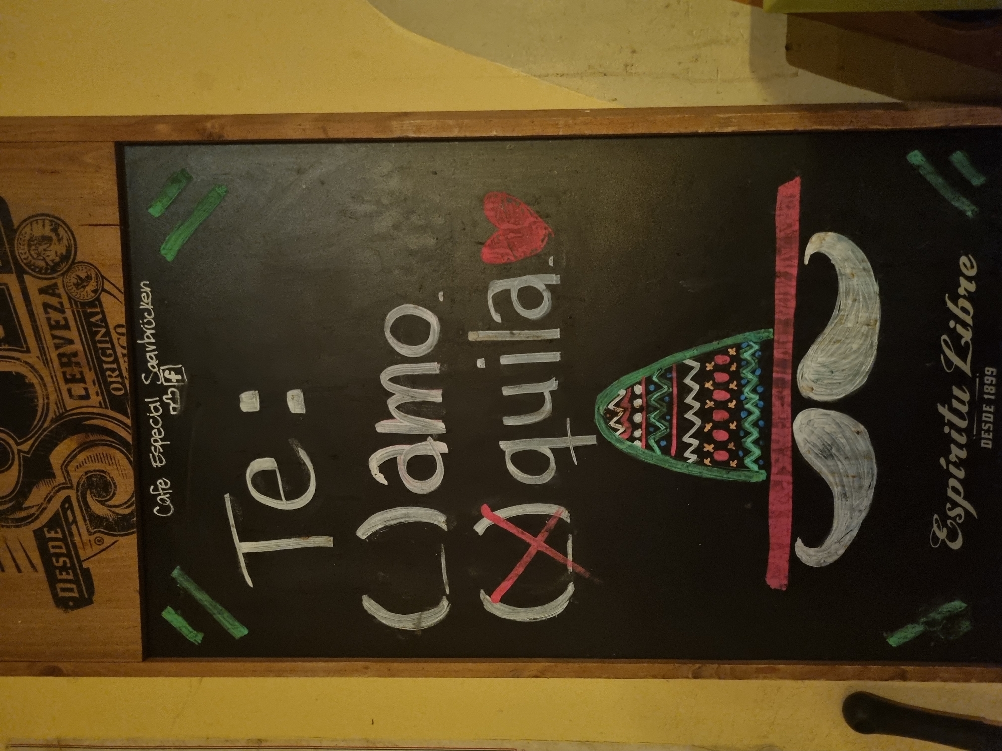 Evening bar scenes documented in Saarbrücken featuring chalkboard menu