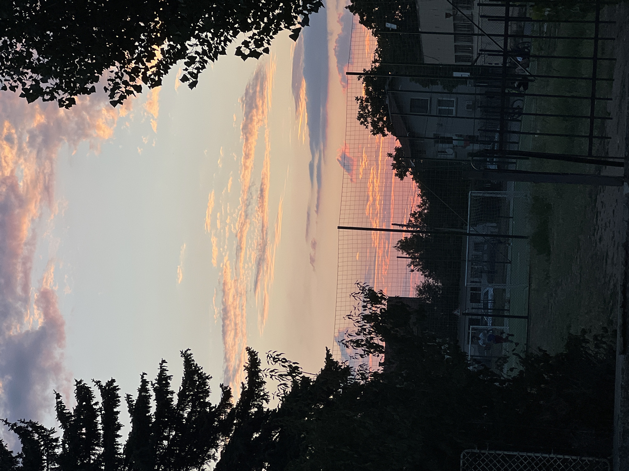 Sunset silhouette over an outdoor sports field