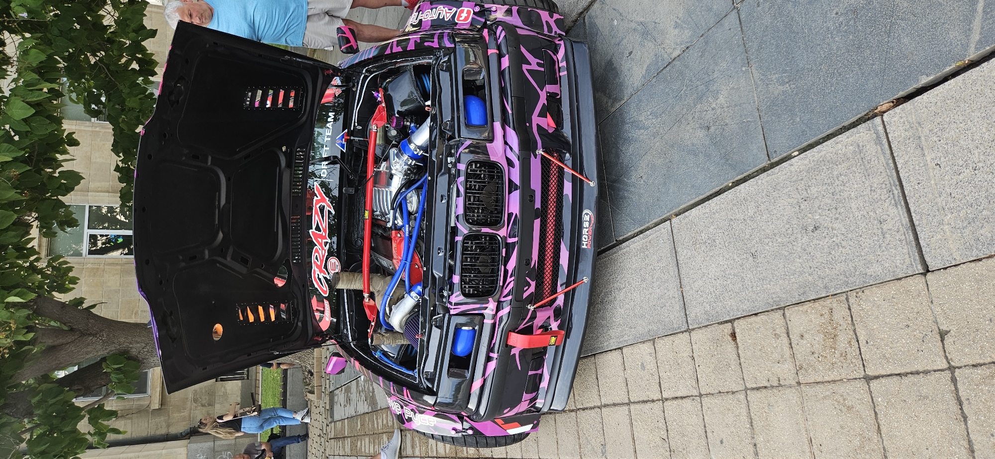 Modified racing cars displayed with open hoods in Ruse
