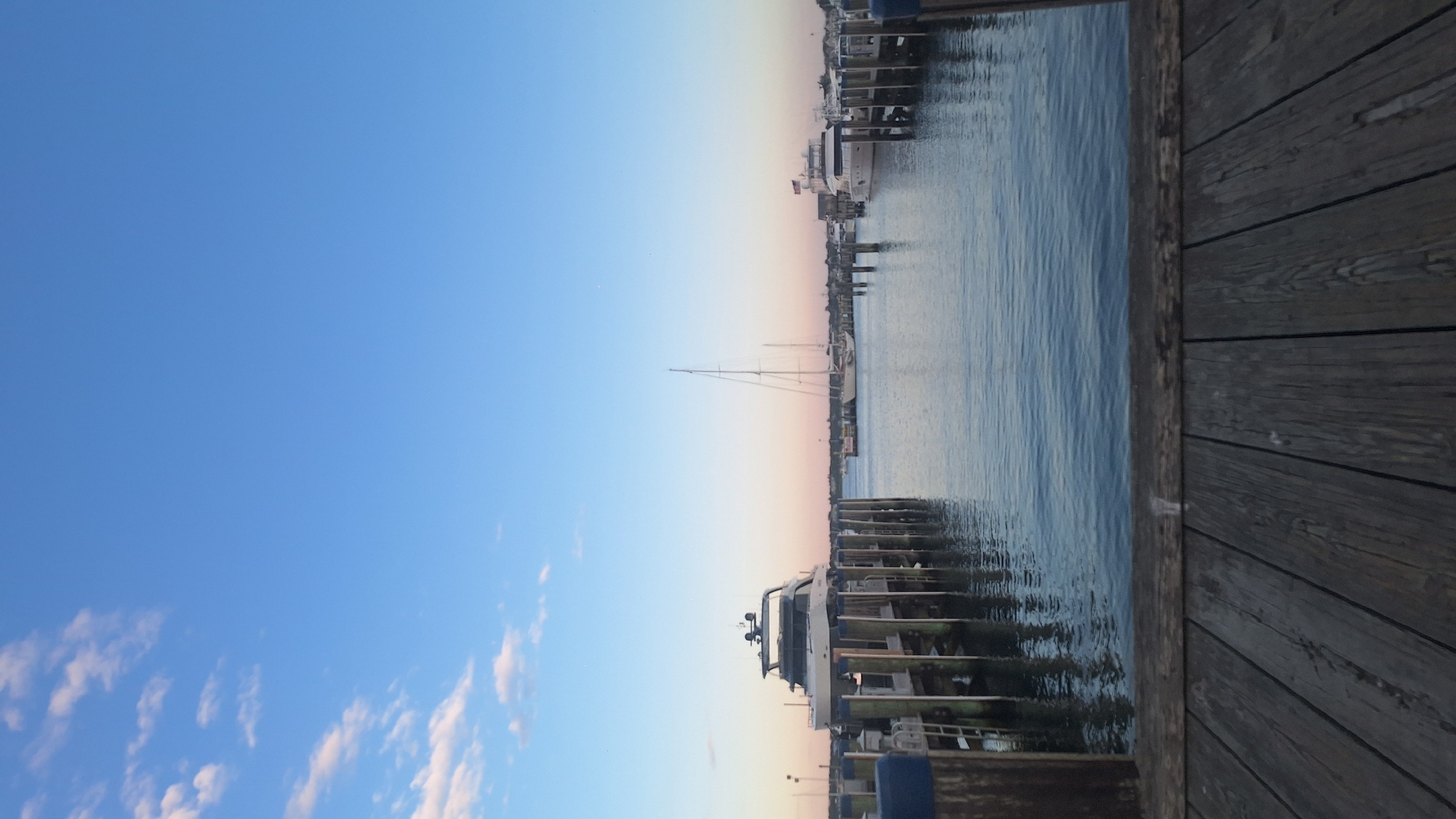 Nantucket harbor at golden hour, ferries and yachts docked at dusk