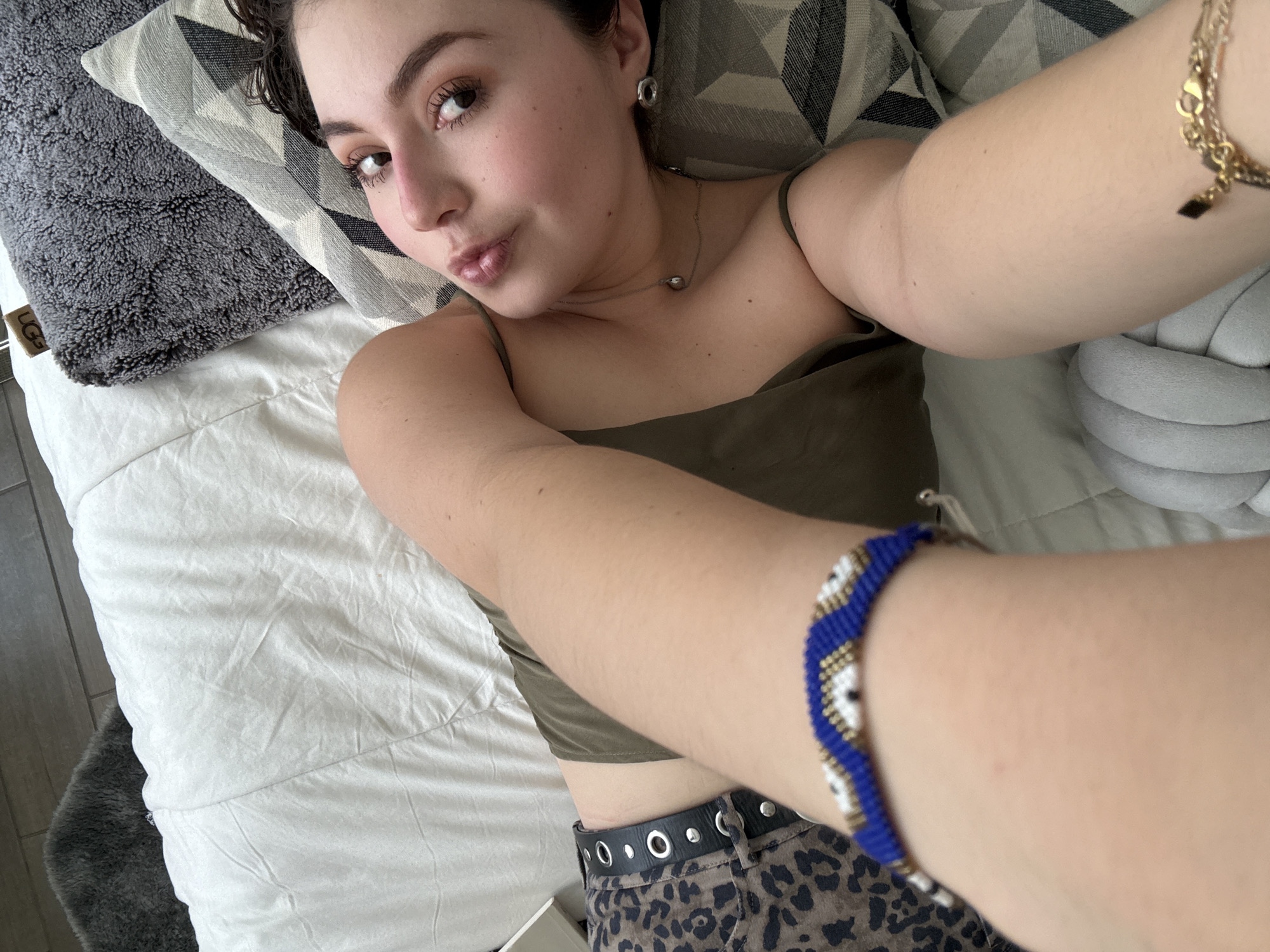 Woman takes selfie on bed in Mexico City