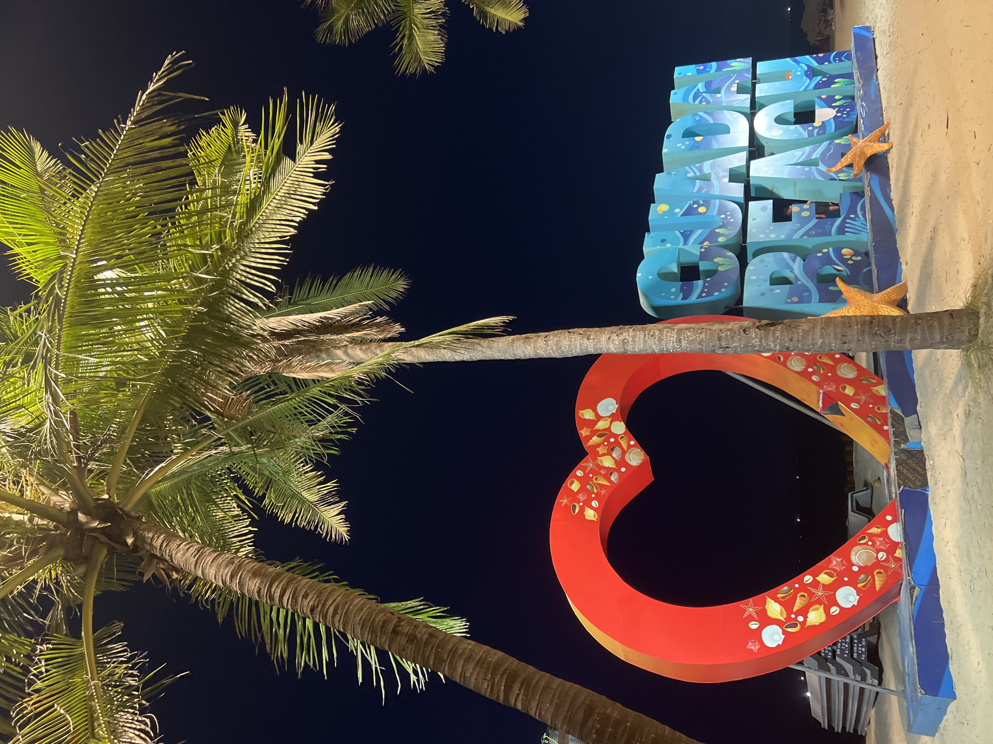 Hoi An beachfront at dusk and night, lit walkways and coastal decor