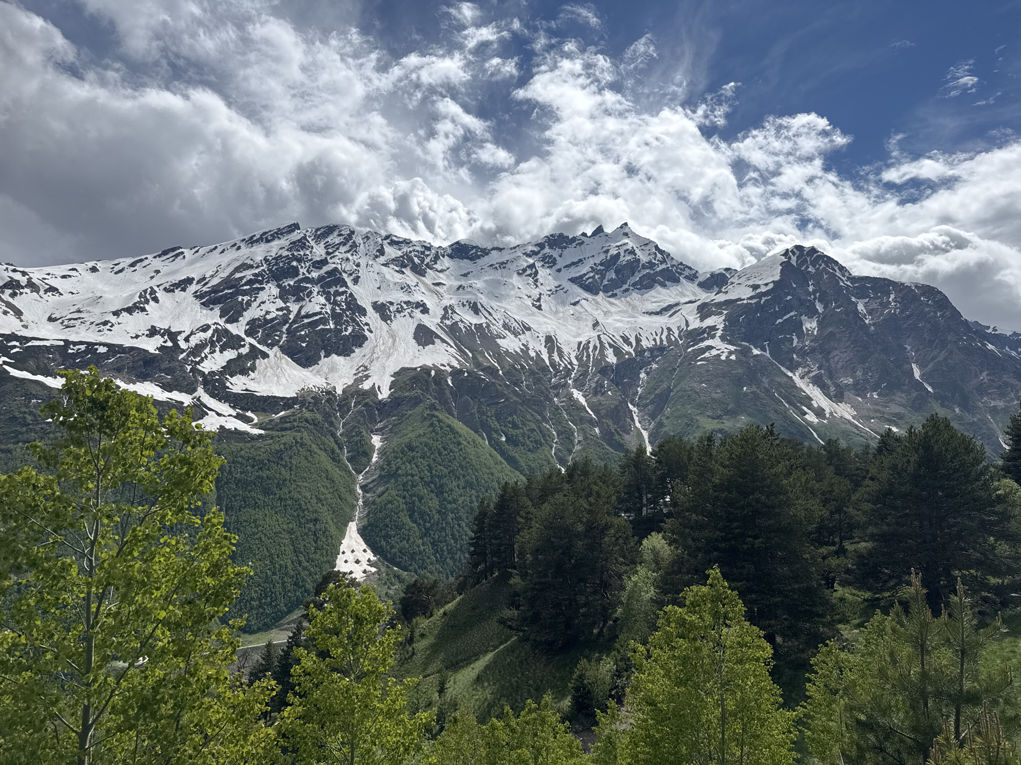 Hiking trail winds through alpine terrain near Terskol's mountain peaks