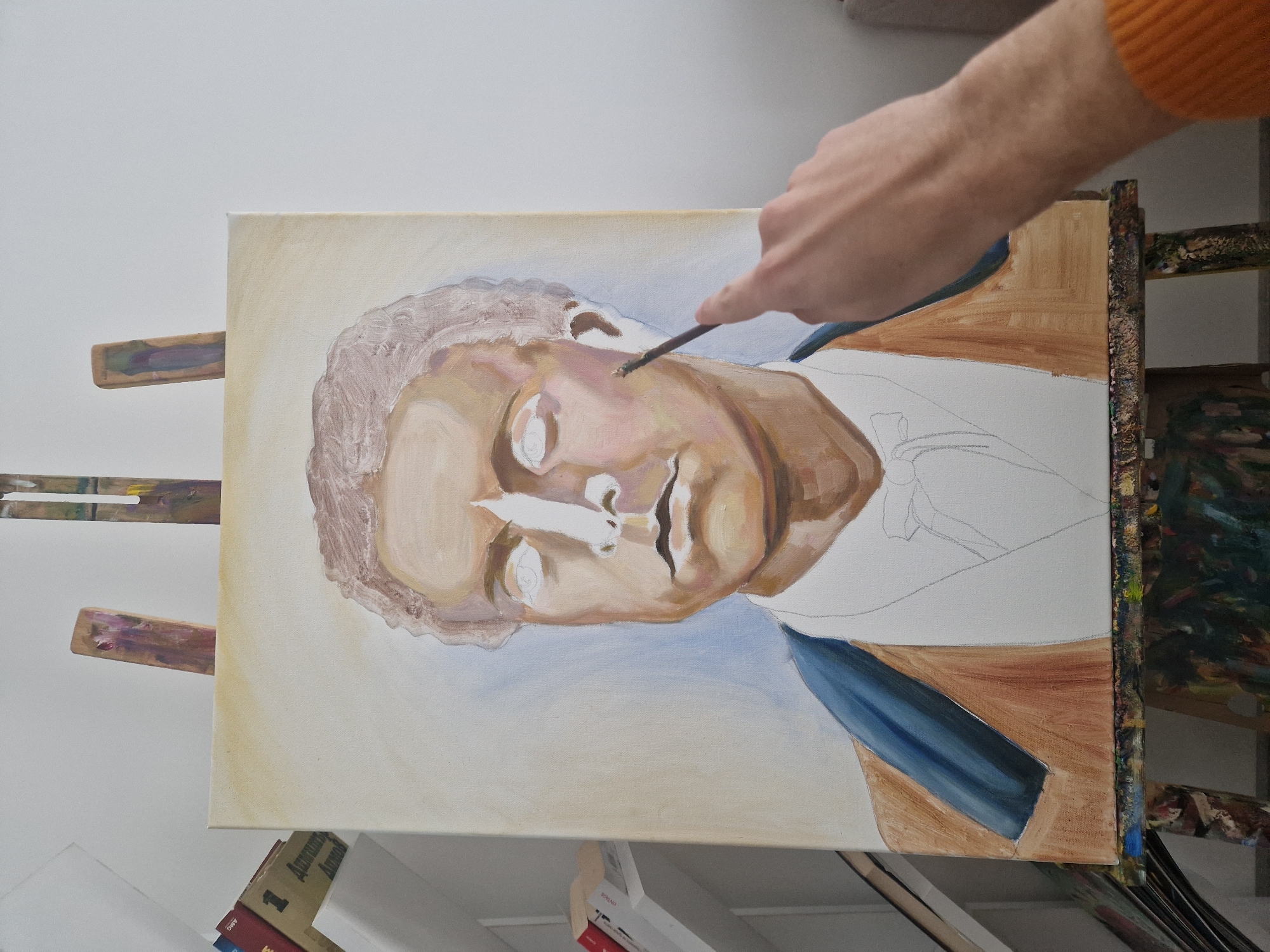 Artist paints male portrait on canvas early morning