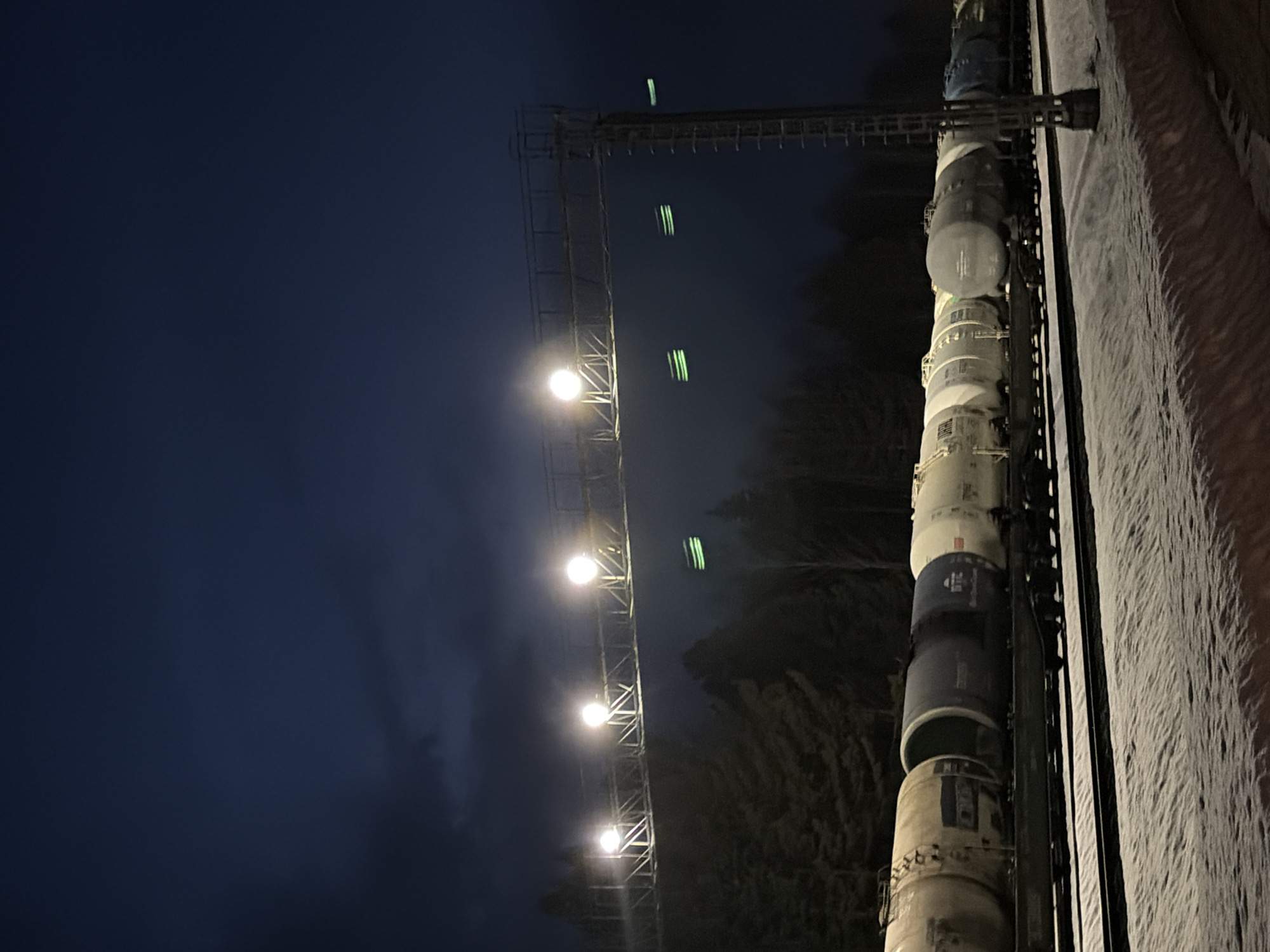 Freight train passes through snowy Kemul railway at night