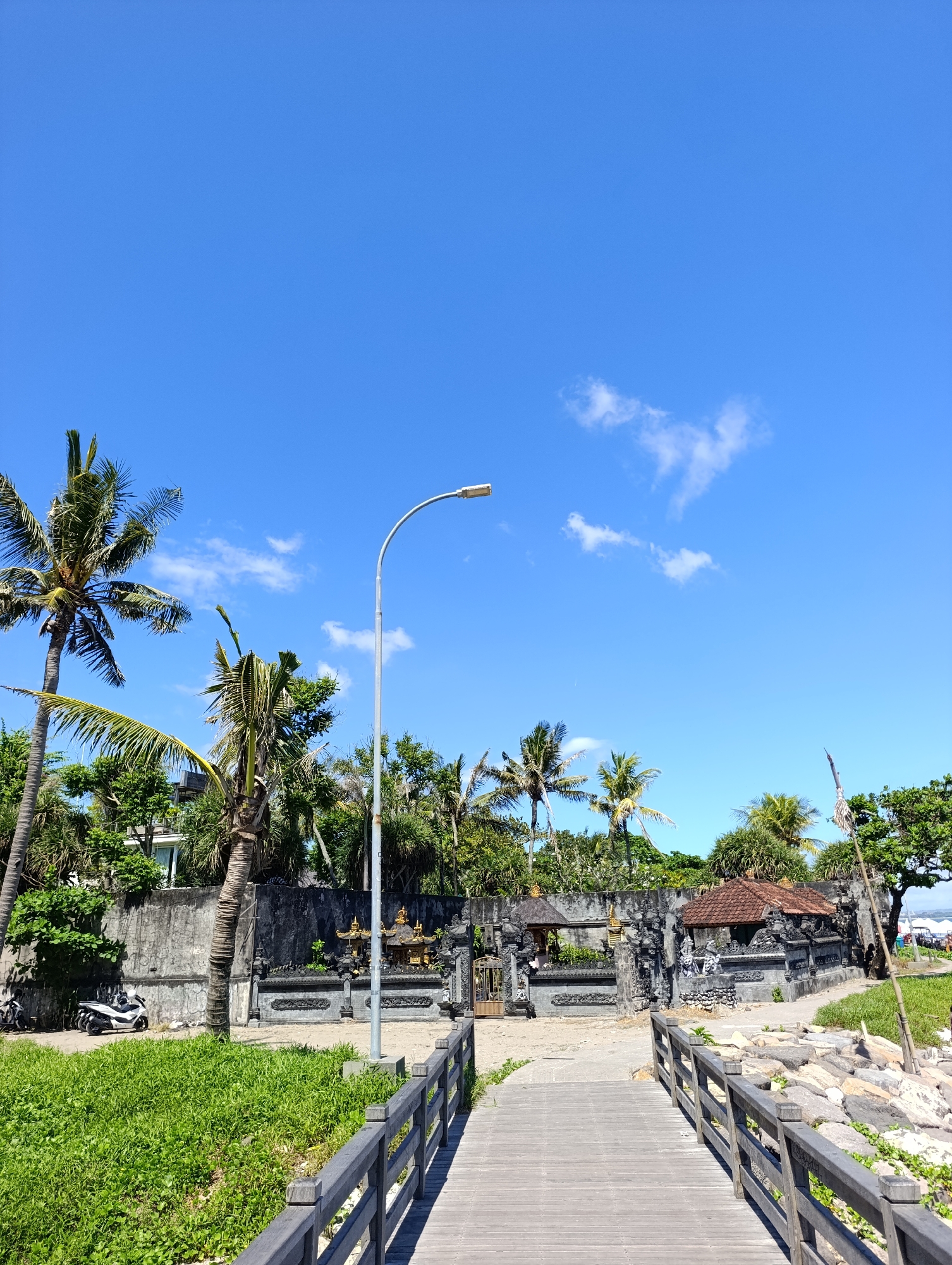 Wooden bridge to Balinese temple documented in North Kuta