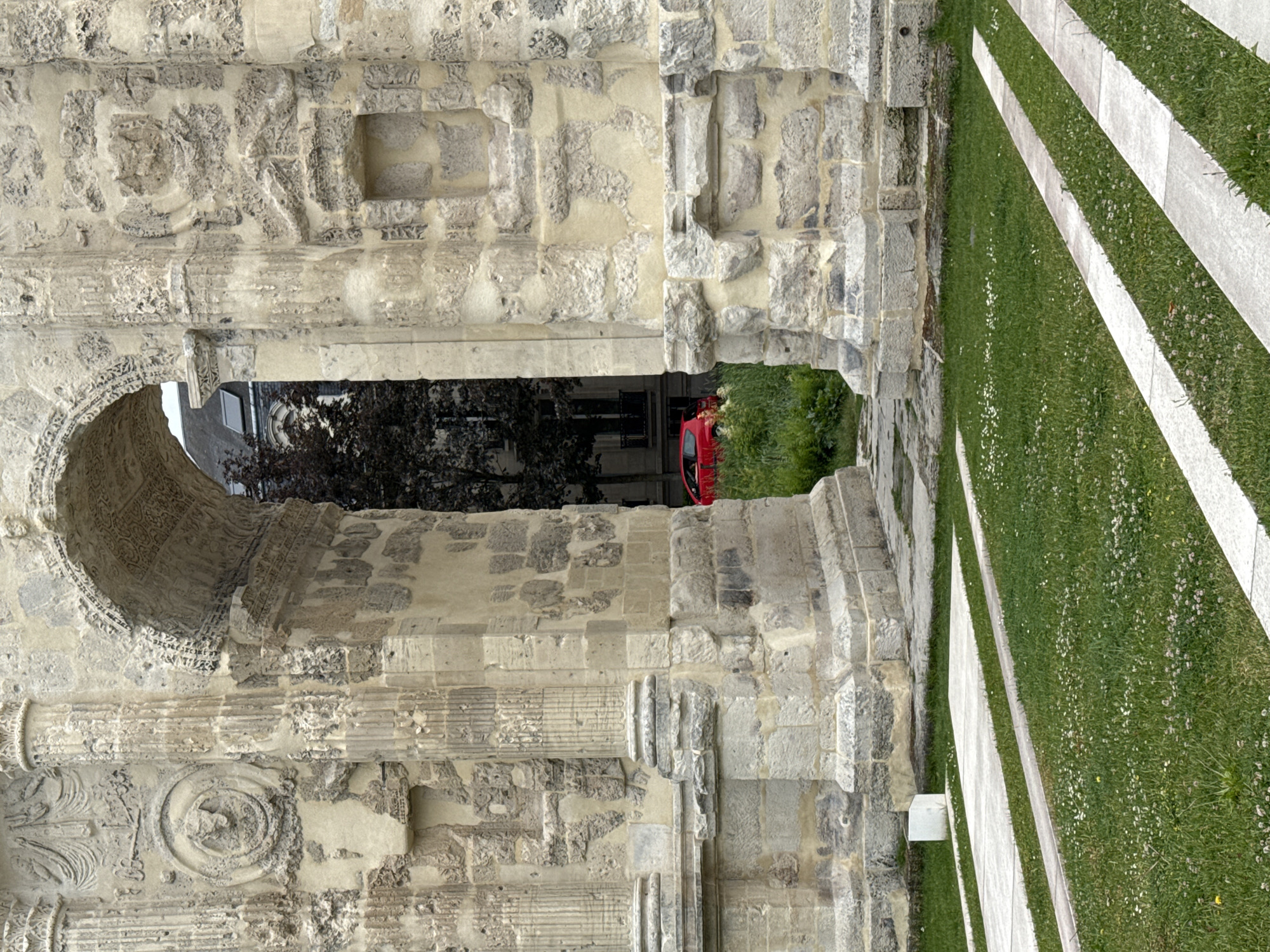 Tourist documents historic architecture during afternoon walk through Reims