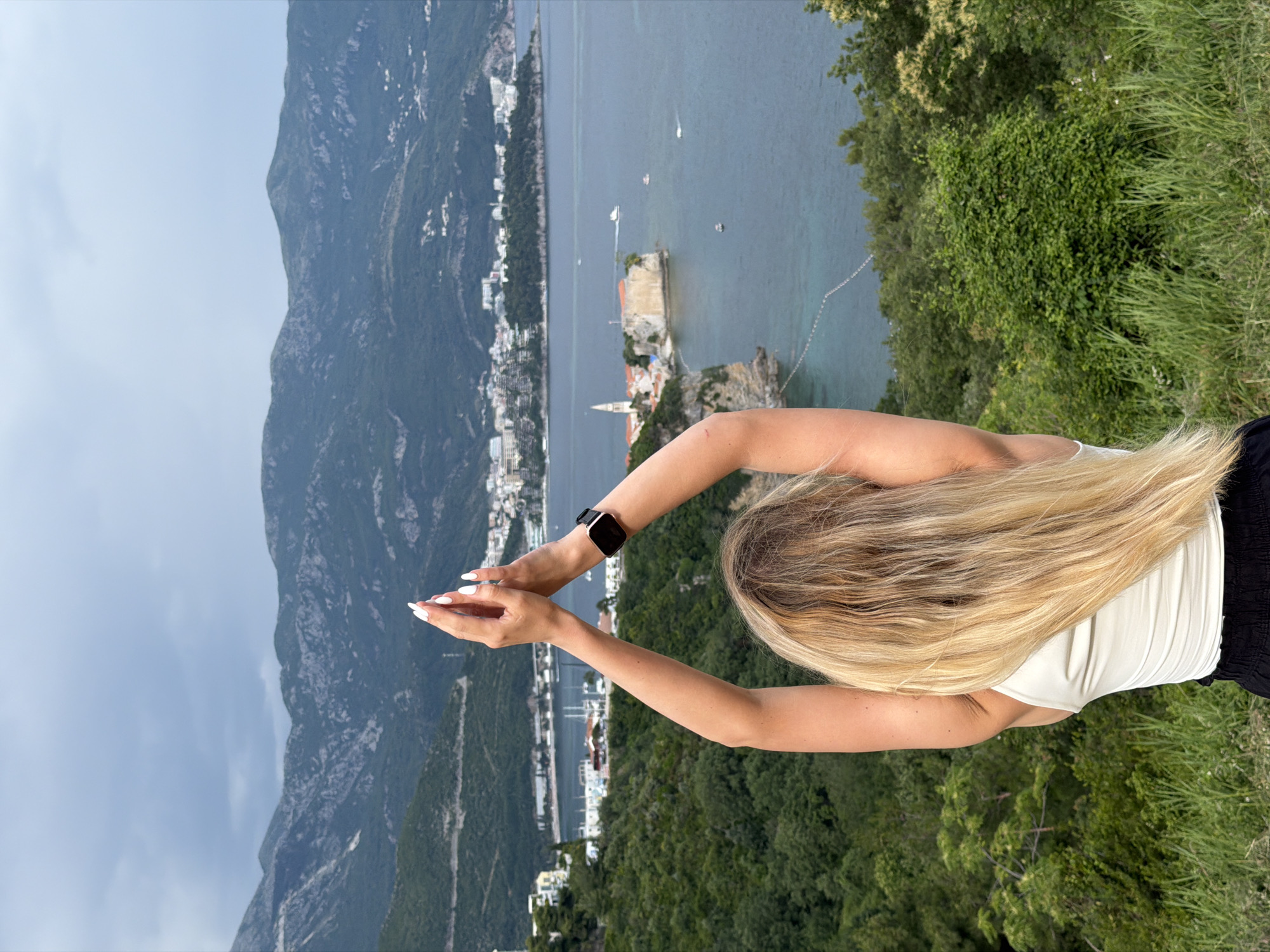 Woman poses for photos at scenic Budva overlook